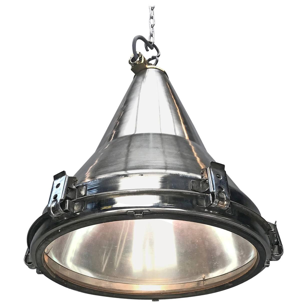A reclaimed industrial stainless steel conical ceiling pendant. 

This light fixture is one of many reclaimed from decommissioned cargo ships made in Korea c1980 and is very well designed and constructed.  They were originally used on masts and