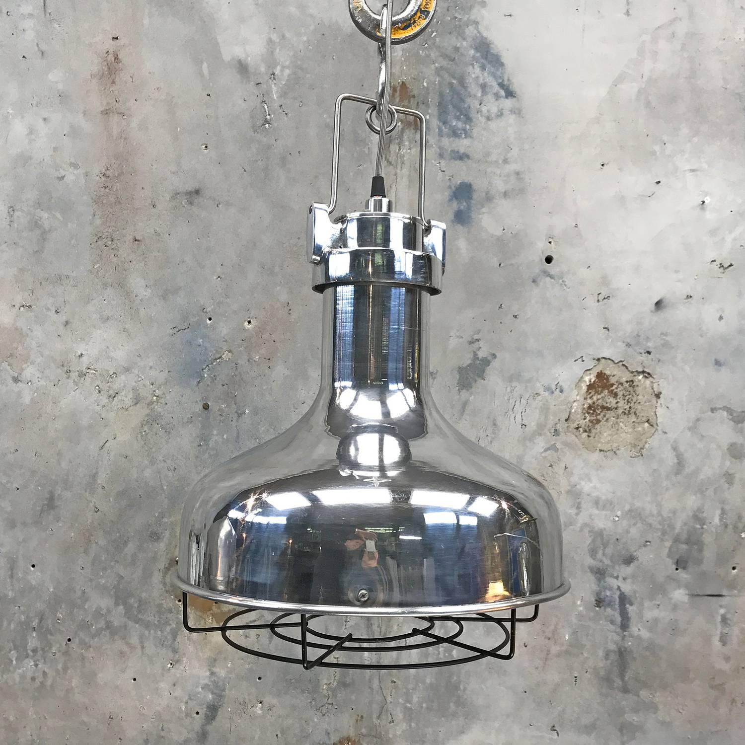 Aluminium Engine room pendant.

Originally found in the engine rooms of large sea going vessels such as supertankers and cargo ships built during the 1970s.

Spun aluminium dome with cast aluminium top, black steel cage and silver braided