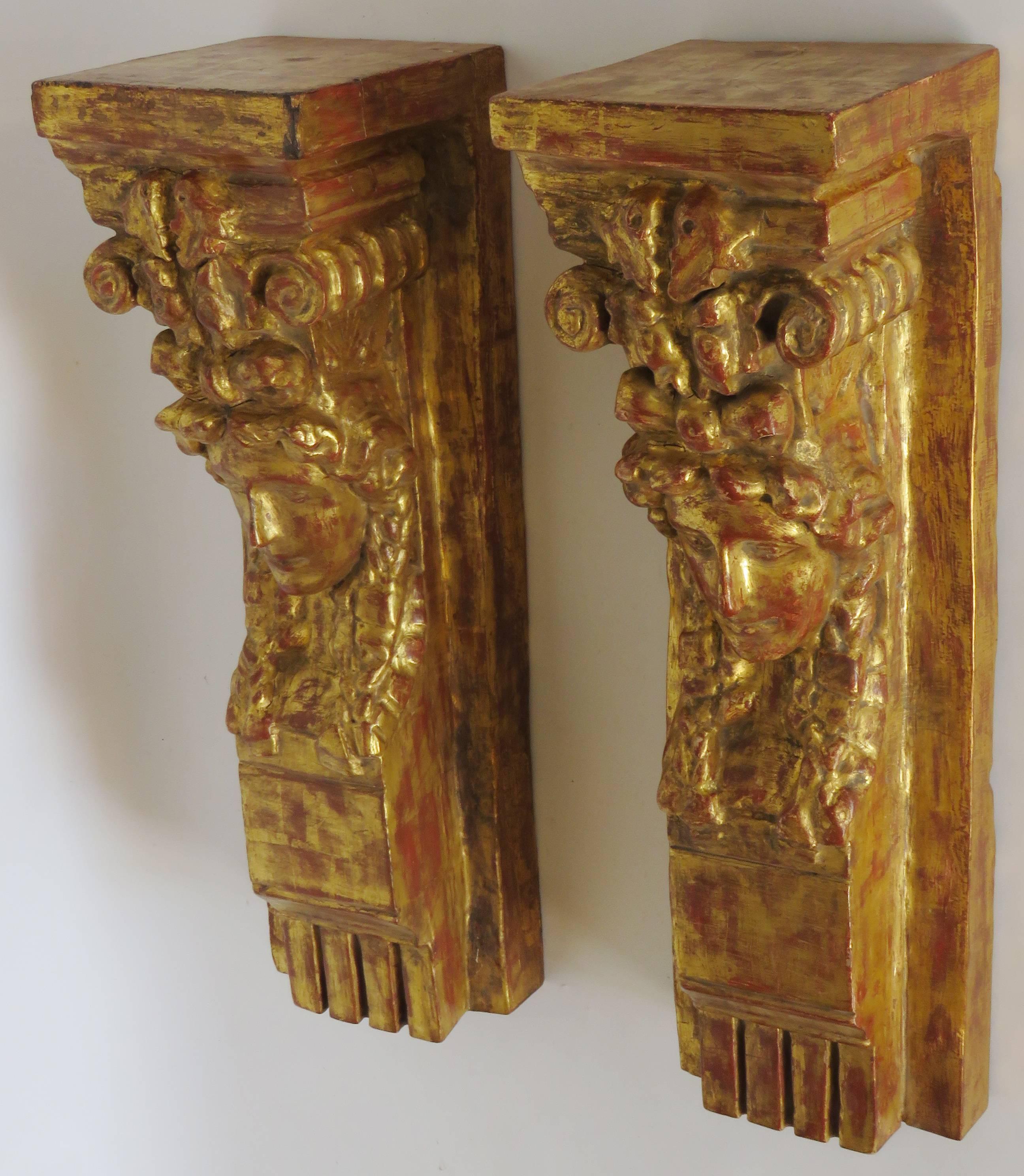 Pair of attractive, slender rectangular giltwood brackets with female face and foliate carving topped by deep molded plinth. Suggestion: Place a custom-made double glass top to make a wall console.