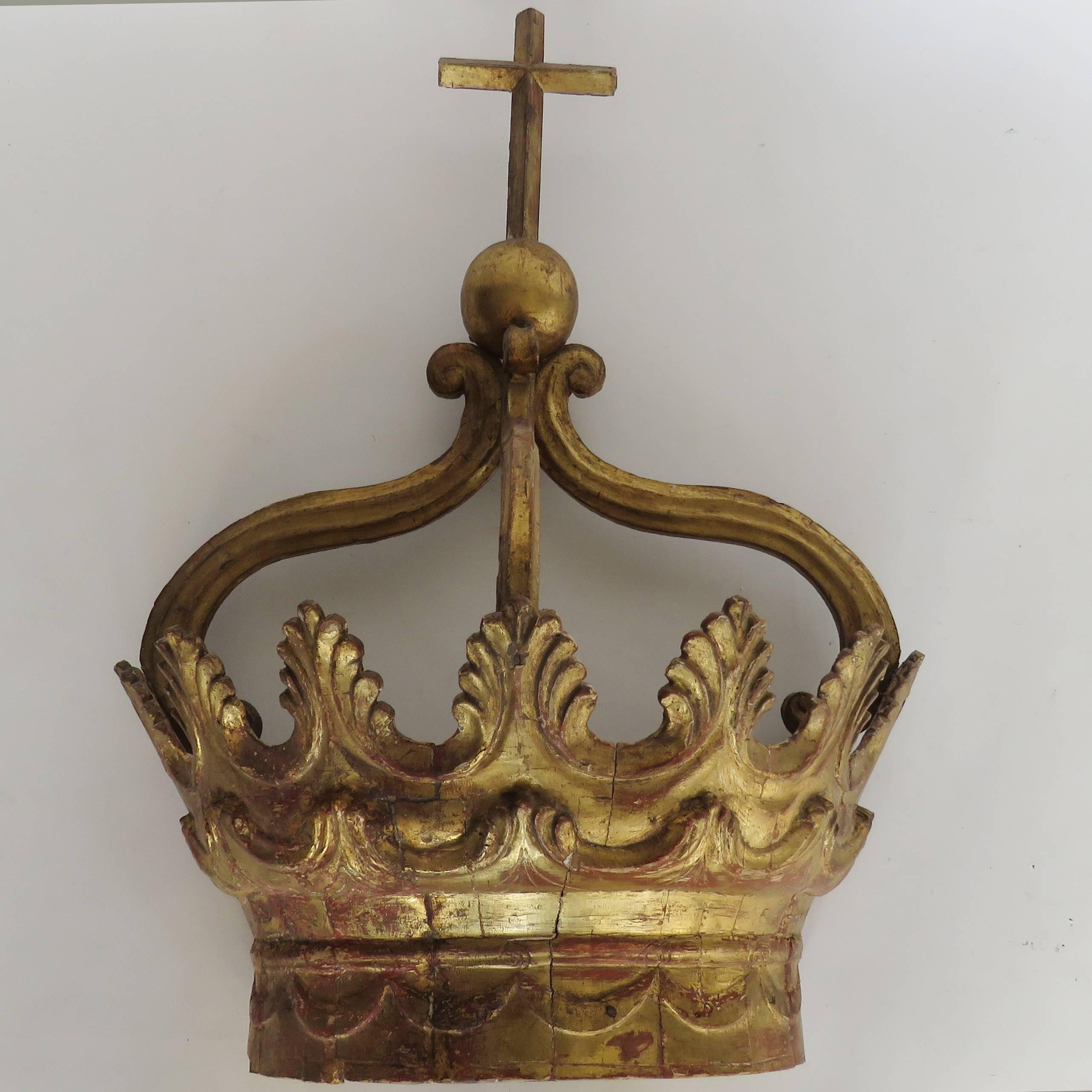 Large giltwood crown, swag decoration on lower band topped by two layers of upright acanthus leaves surmounted by three arms supporting a ball and cross.