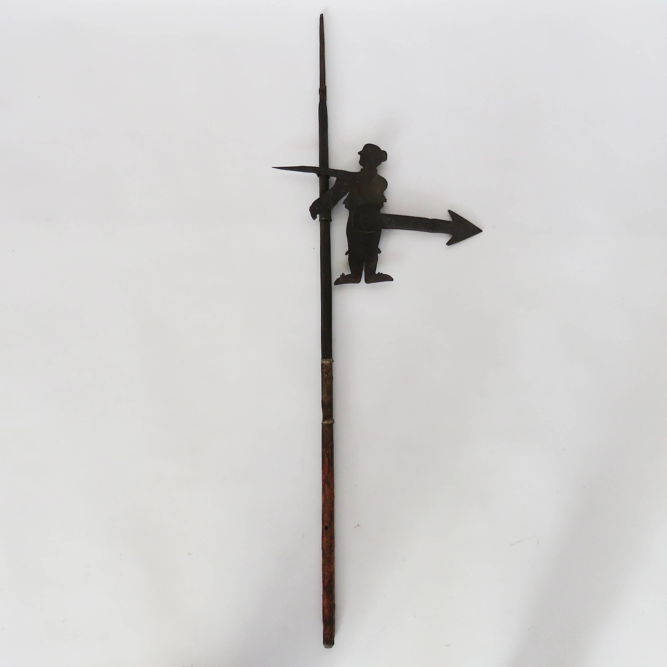 Thick hand-forged iron weather-vane with figure and pointing arrow. 
Measures: Figure size 11