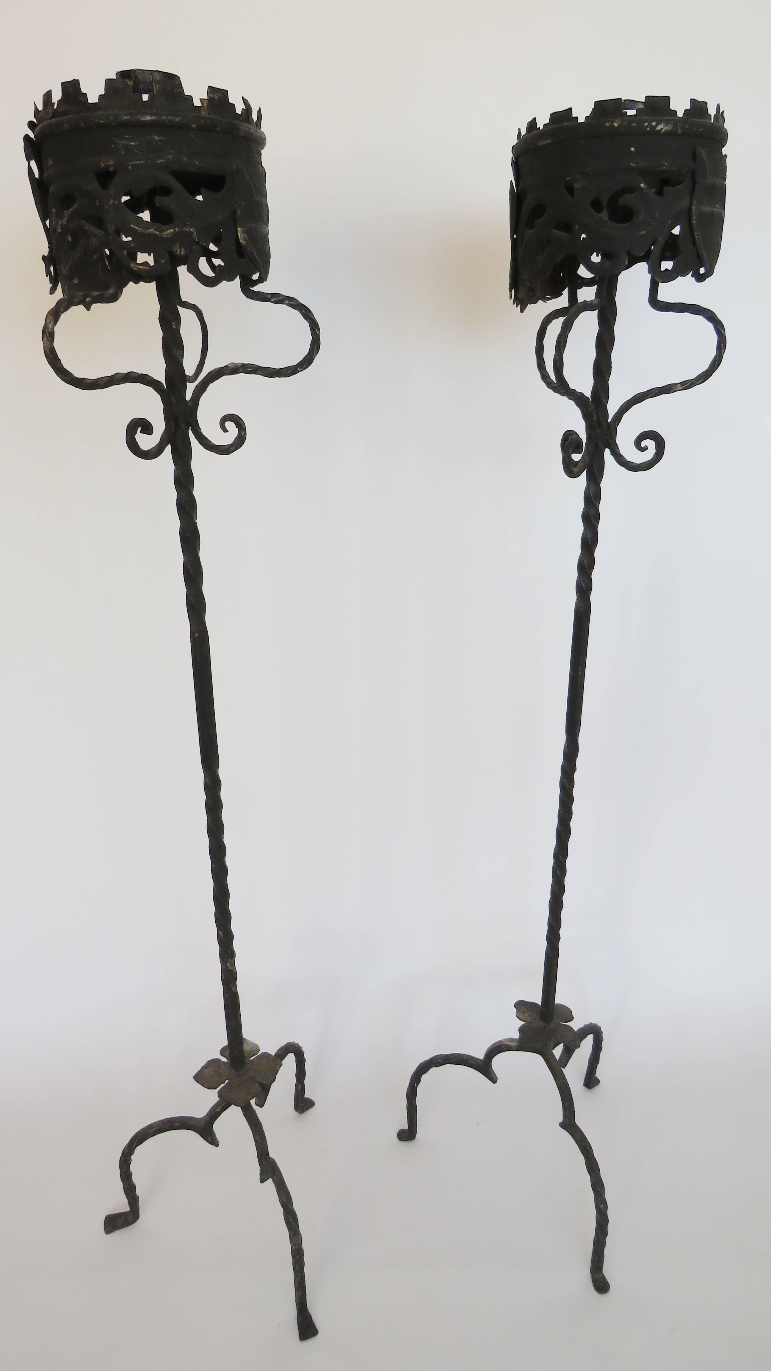 Large elaborately decorated platform on a rod standard supported on twisted arched tripod. These torchères could be reconverted into floor lamps if rewired.