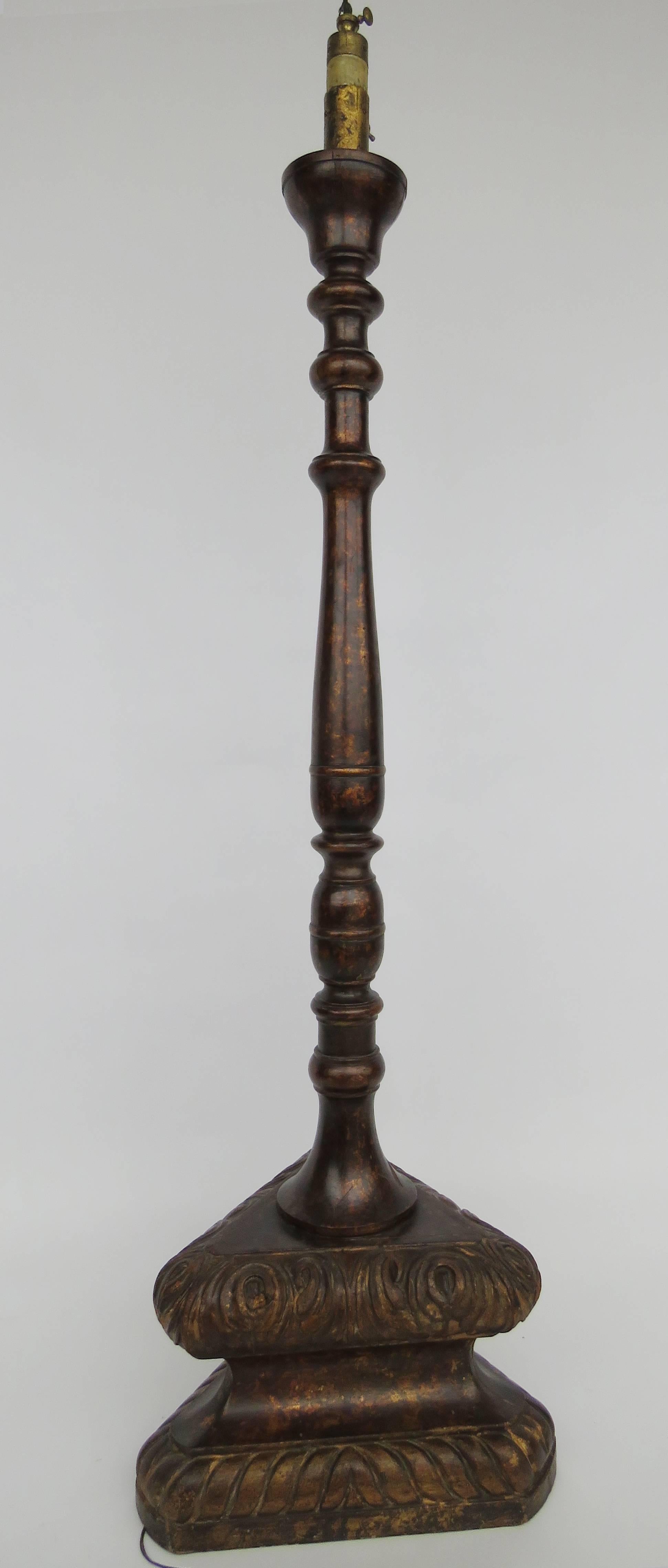Polychrome, turned baluster column, raised on a triangular plinth, molded with scrolling and rope twist carving.