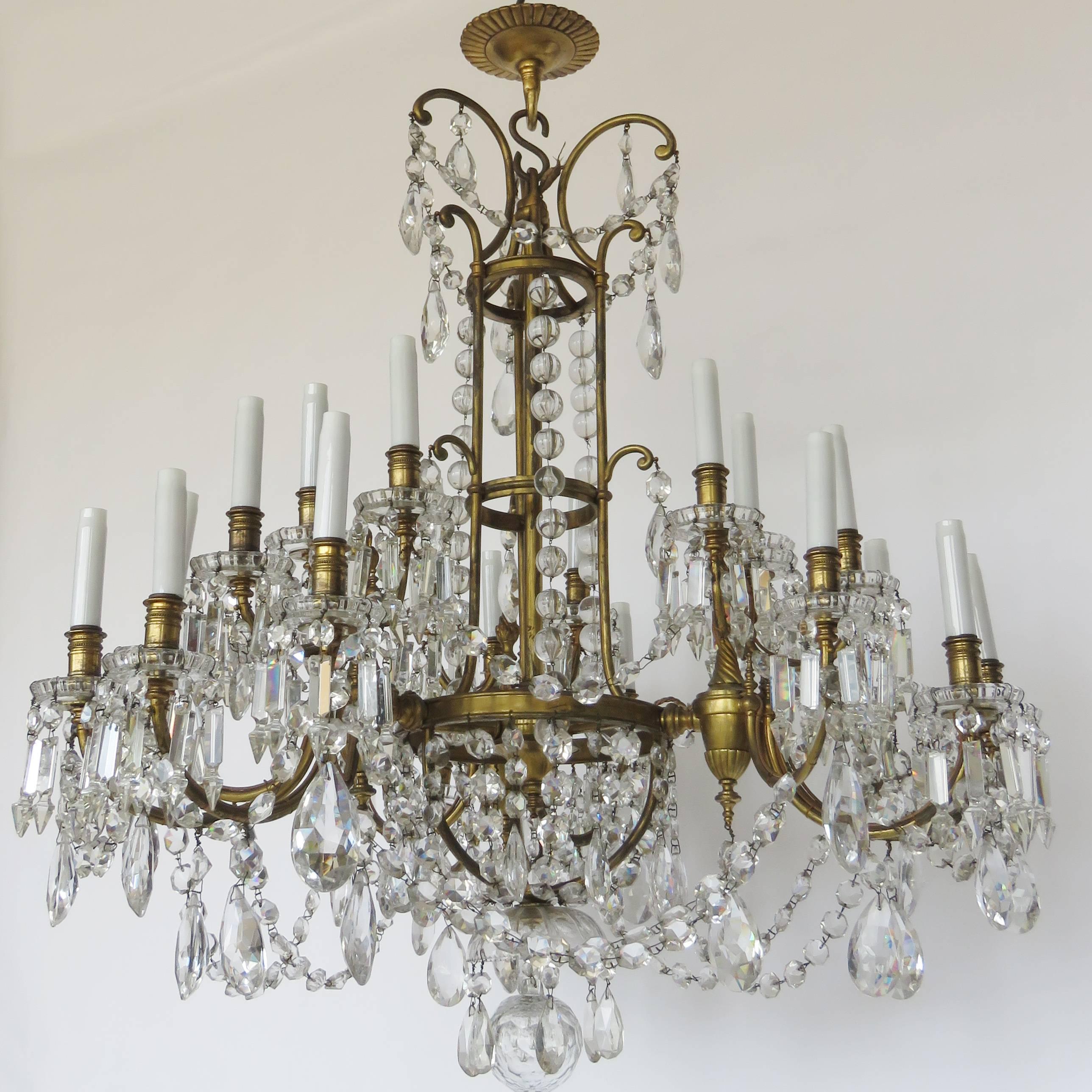 Magnificent bronze chandelier, extensive Baccarat crystal beading and teardrop pendants with 21 candle arm lights.