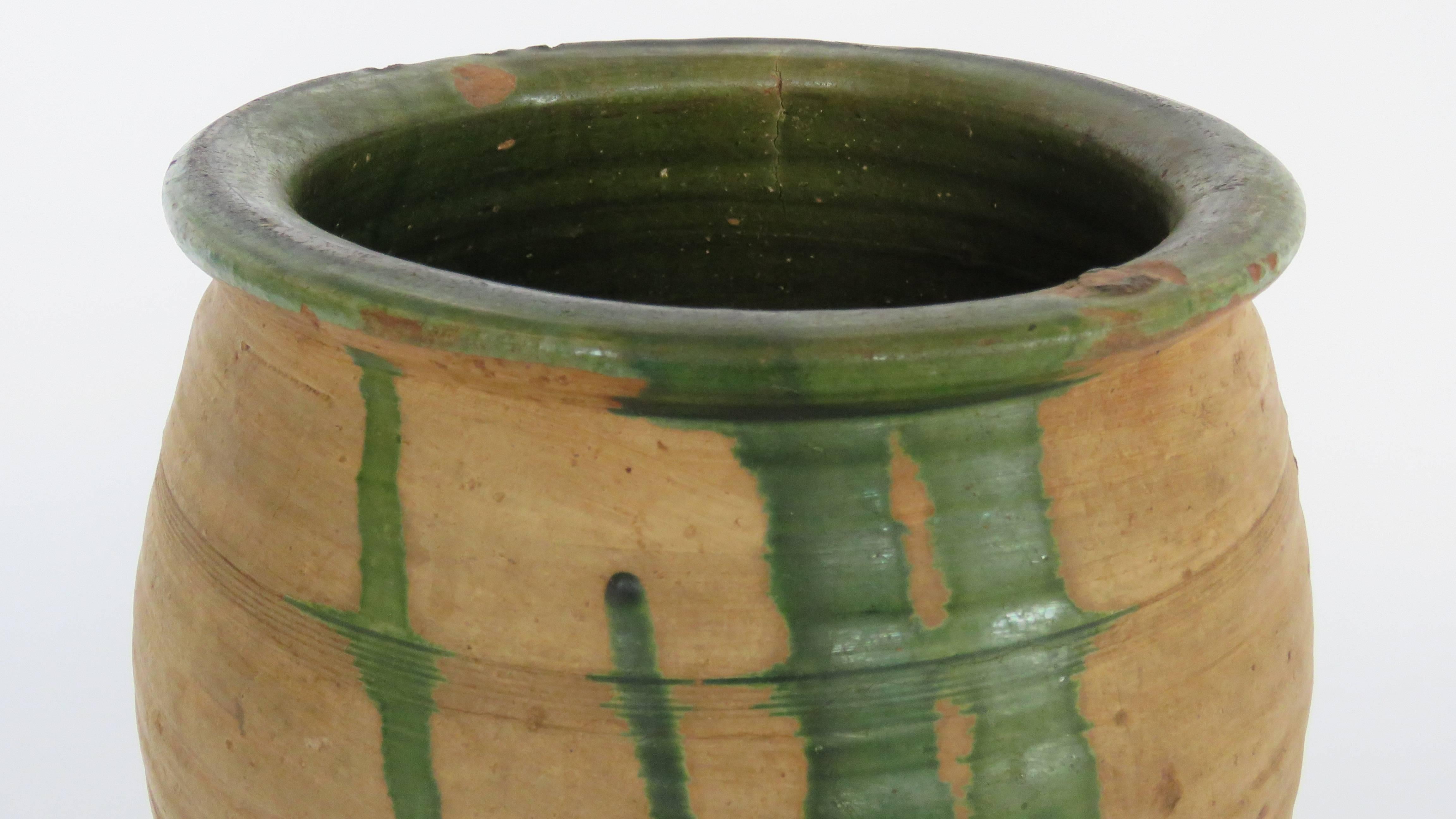 Hand coiled honey pot with morisco green drippy glaze.

Shipping costs per item diminish with purchase of additional items.
Photo of collection of pots it is to show more are available. Other pots are not included in price.