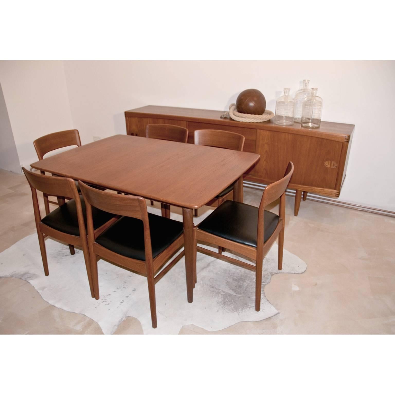 Danish teak dining set for KS Korub Møbler designed by Kai Kristiansen. Take  a note of the very beautiful, sculpted shape of the Chairs. The table comes with three leaves making if very much appropriate to host a large sit down dinner. 