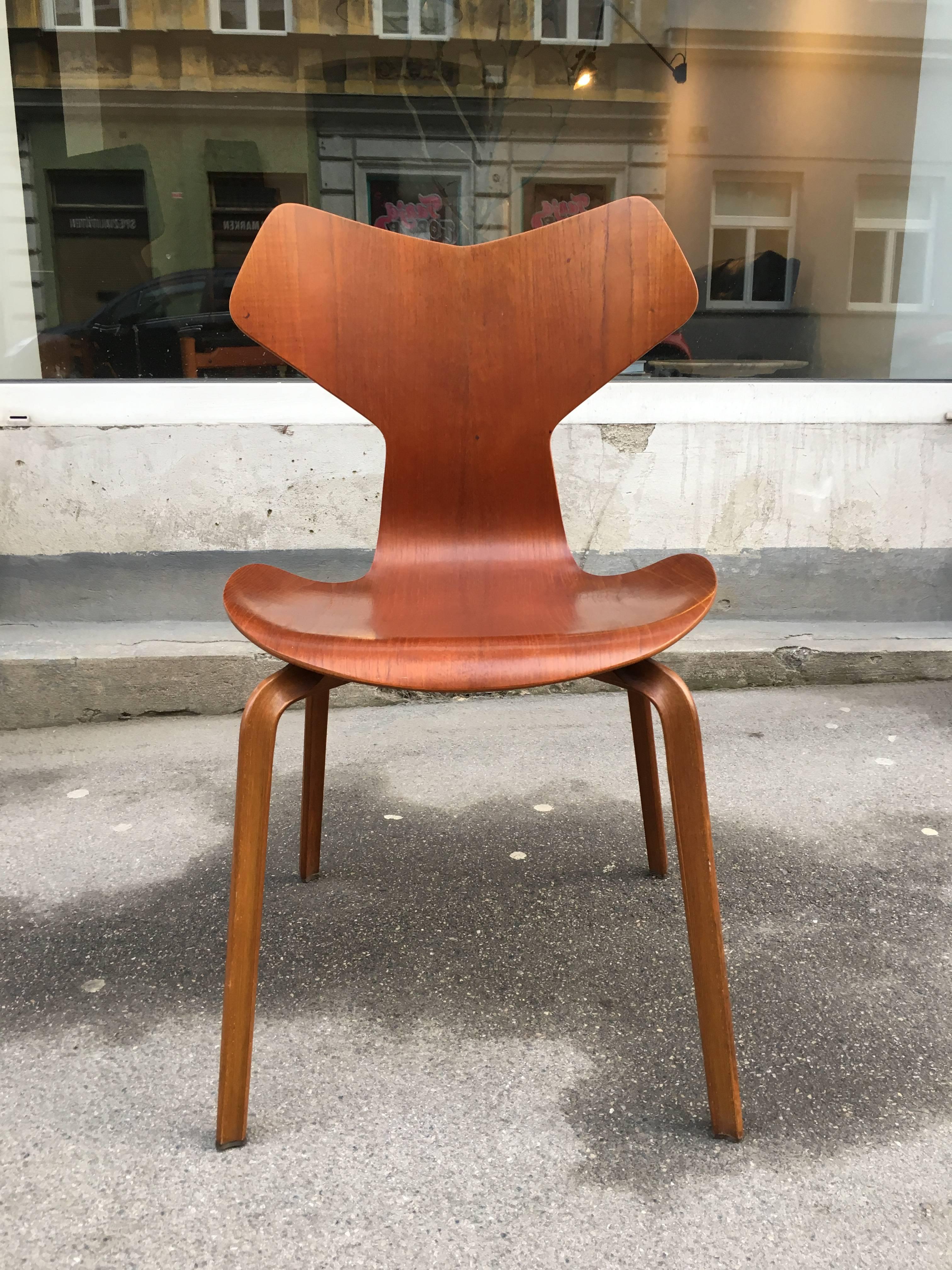 Grand Prix chair from the seemingly rare first edition by Fritz Hansen. Designed in 1957 and manufactured in the following year this chair is marked and retains it's original laminated teak seating surface and legs of bended solid beech. Gently