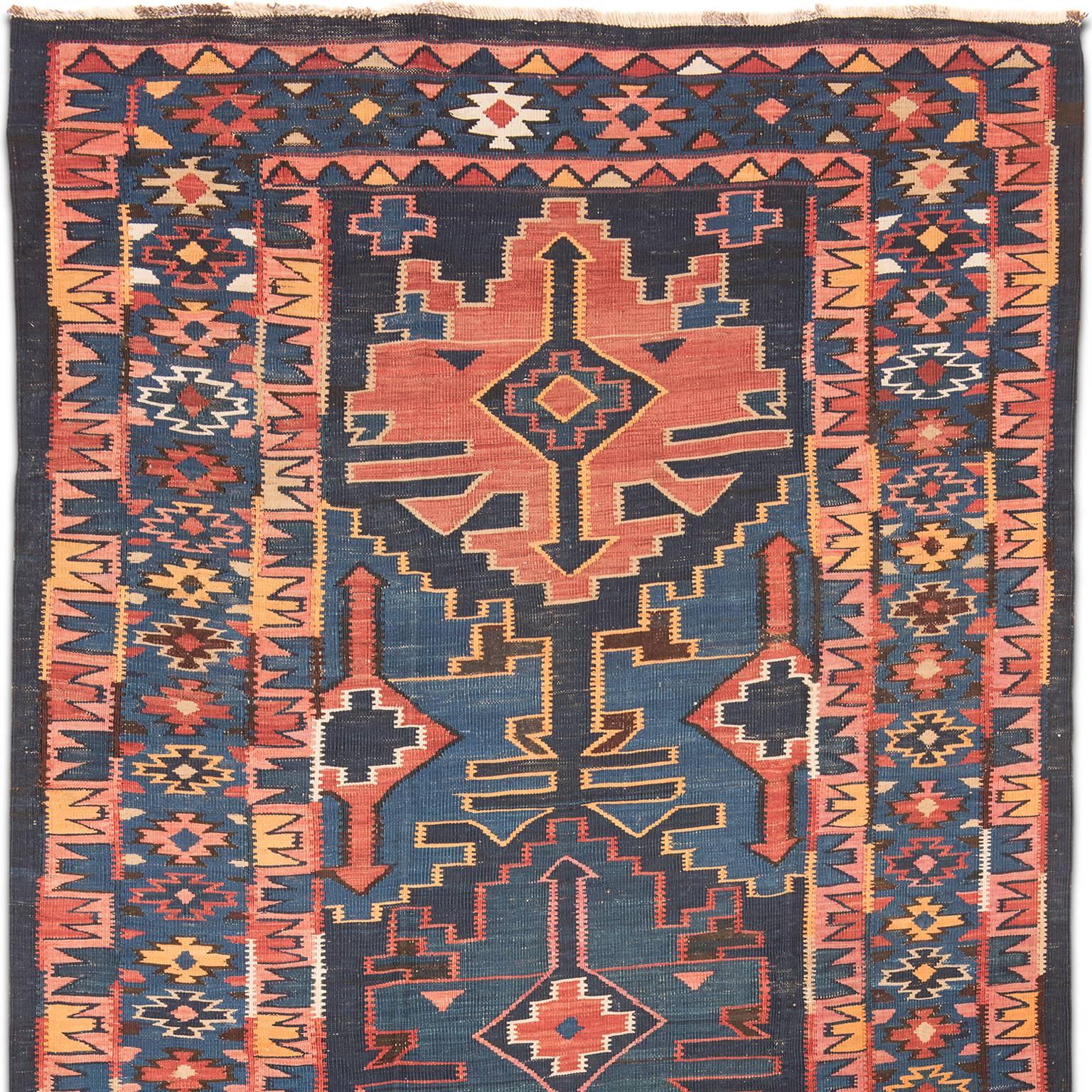 This antique Avar Kilim was woven in the Dagestan area of the east Caucasus in the early 20th century, circa 1920. The dynamic border complements the central field in both design and a wonderfully abashed colourway.