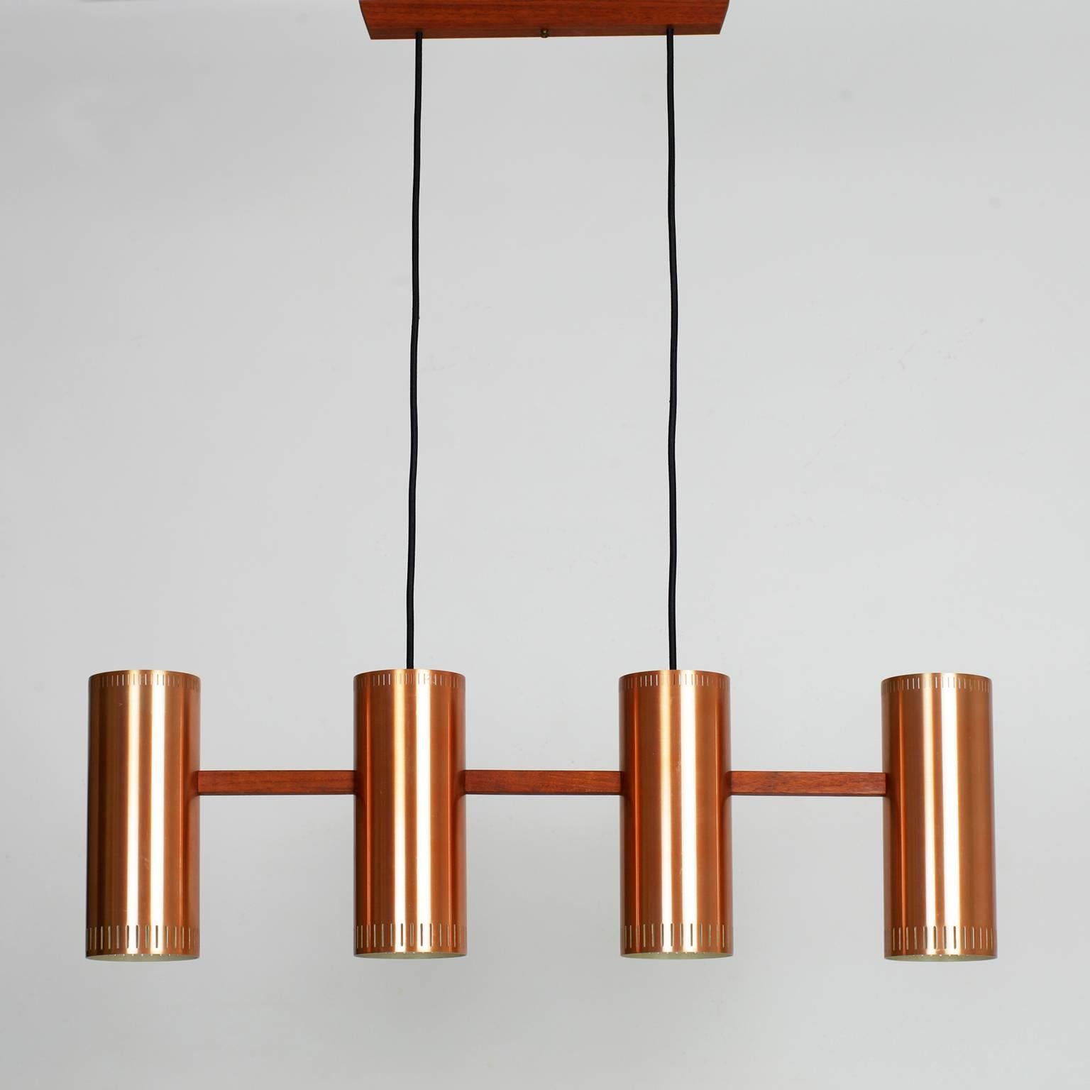 Rare cylinder IV copper and teak pendant designed by Jo Hammerborg in the mid-1960s and produced by Fog & Mørup. 
Four E27 bulbs (one by cylinder) 
Rewired with new black fabric cord.
Very good condition.