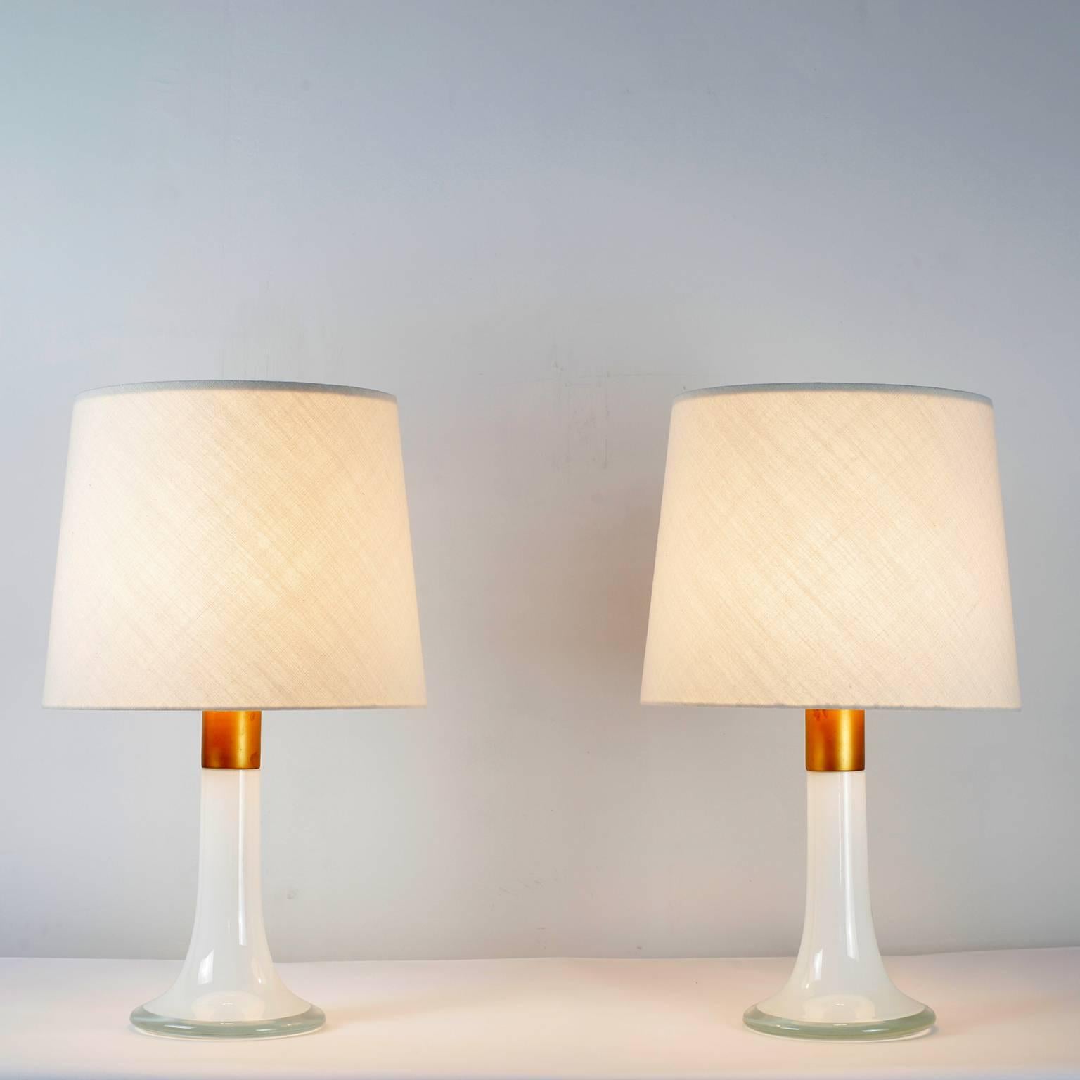 Rare pair of Lisa Johansson-Pape table lamps model 46-017 
White glass and brass details
Ornö Edition 1961 Finland
New lampshades identical to the originals
Height with shades 64 cm - Height without shade 37 cm

Bibliography:
Listed in the catalog