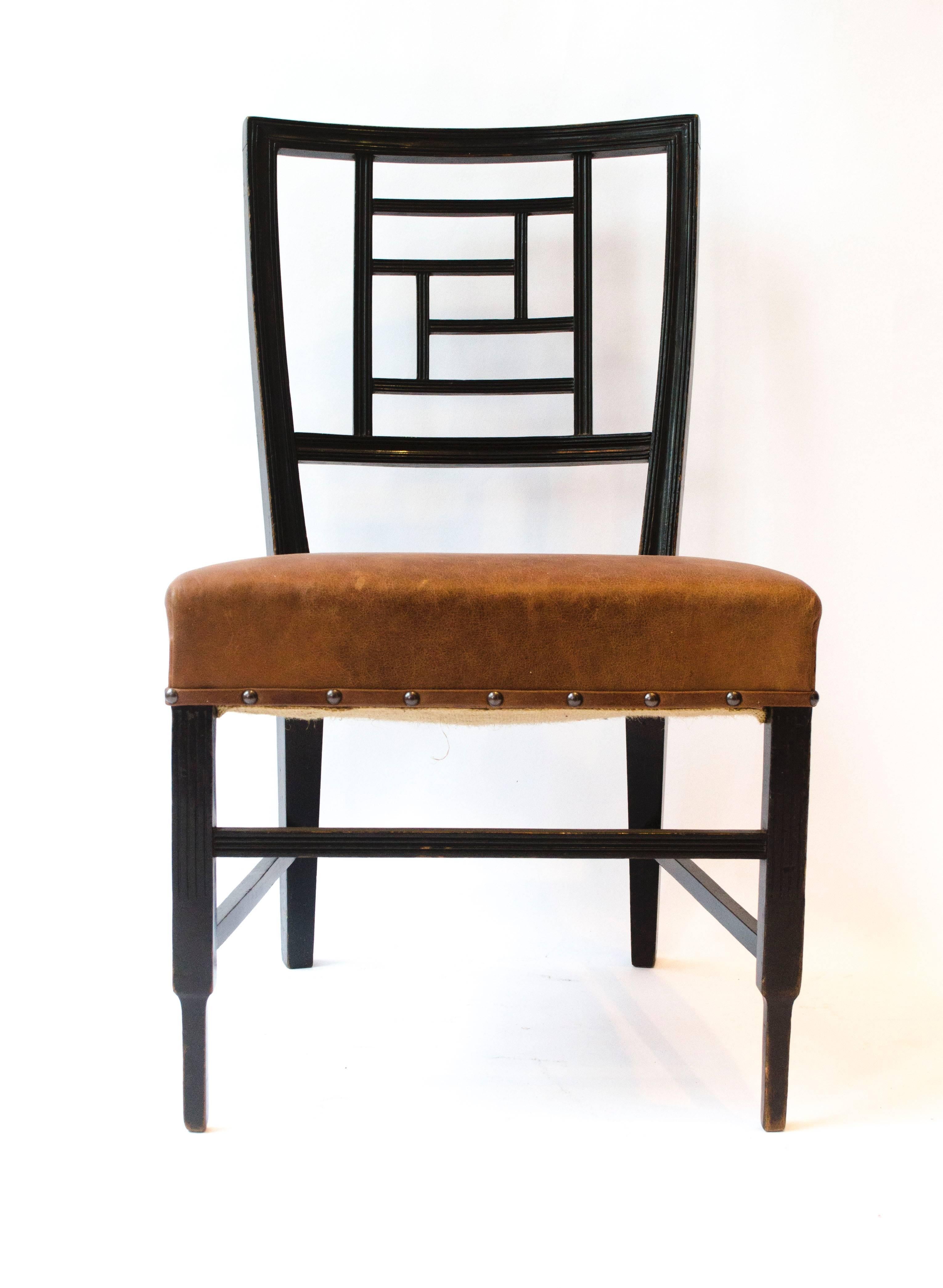 Edward William Godwin, an Anglo-Japanese ebonized side chair, probably made by William Watt. With a lattice back, a later overstuffed leather seat on square part-fluted supports.
See Soros, Susan Weber ‘The Secular Furniture of E.W. Godwin’, p. 113,