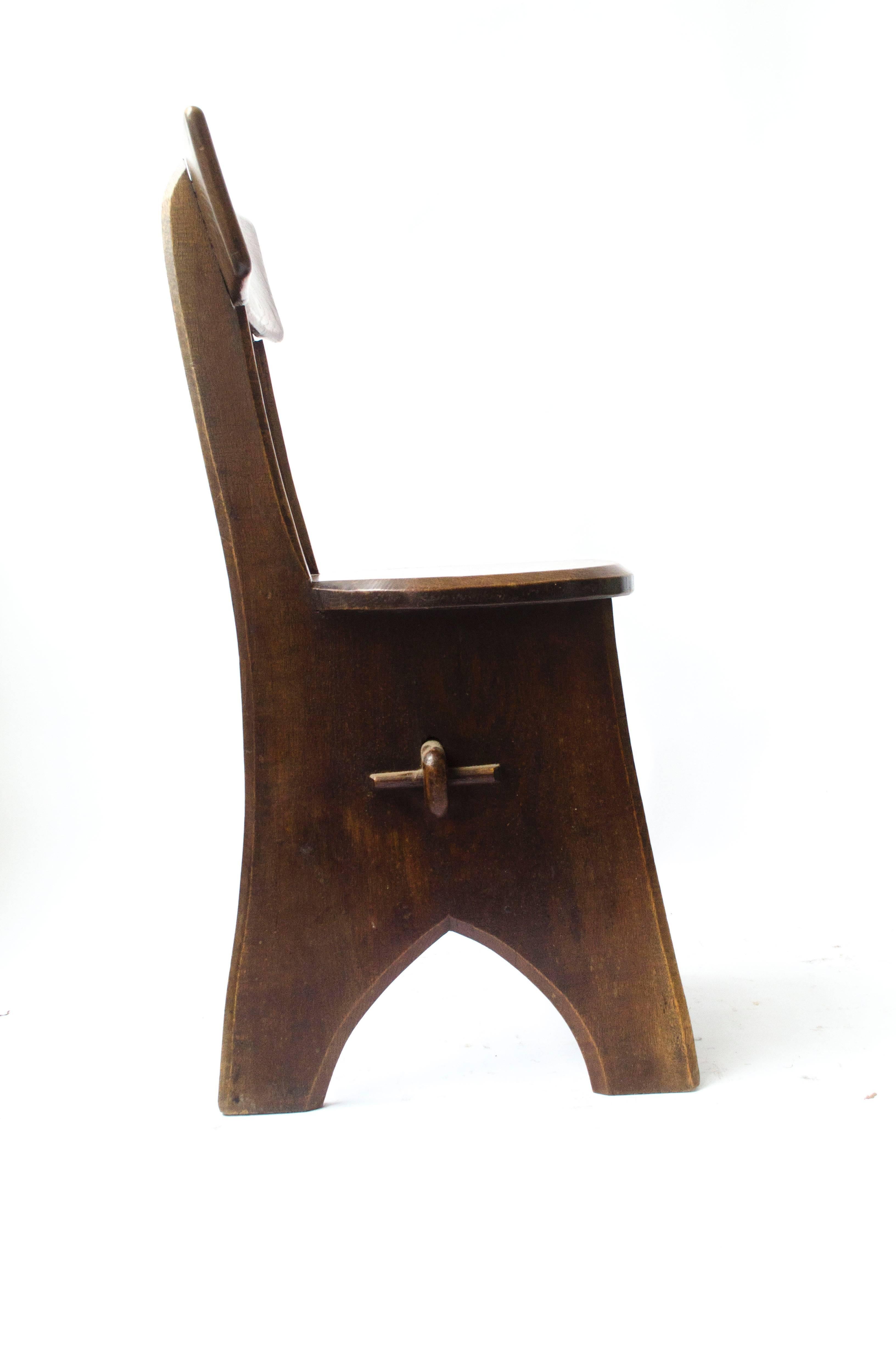 An Arts and Crafts oak chair with through pegged joints, in the style of Edward Welby Pugin, the eldest son of A W N Pugin.