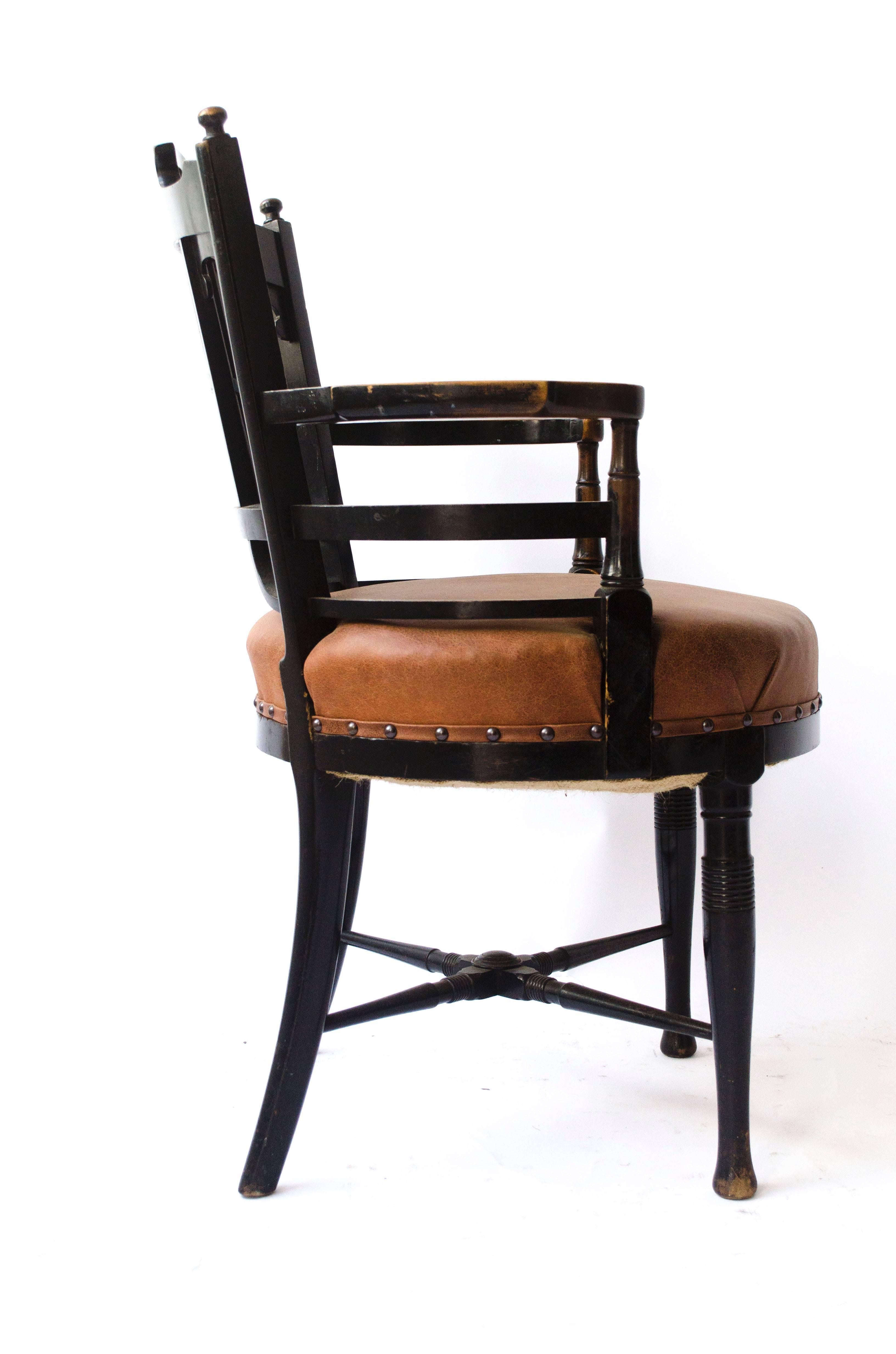 E W Godwin, style of, 
An Anglo-Japanese Old English or Jacobean ebonized armchair.
Professionally upholstered in a quality hide.