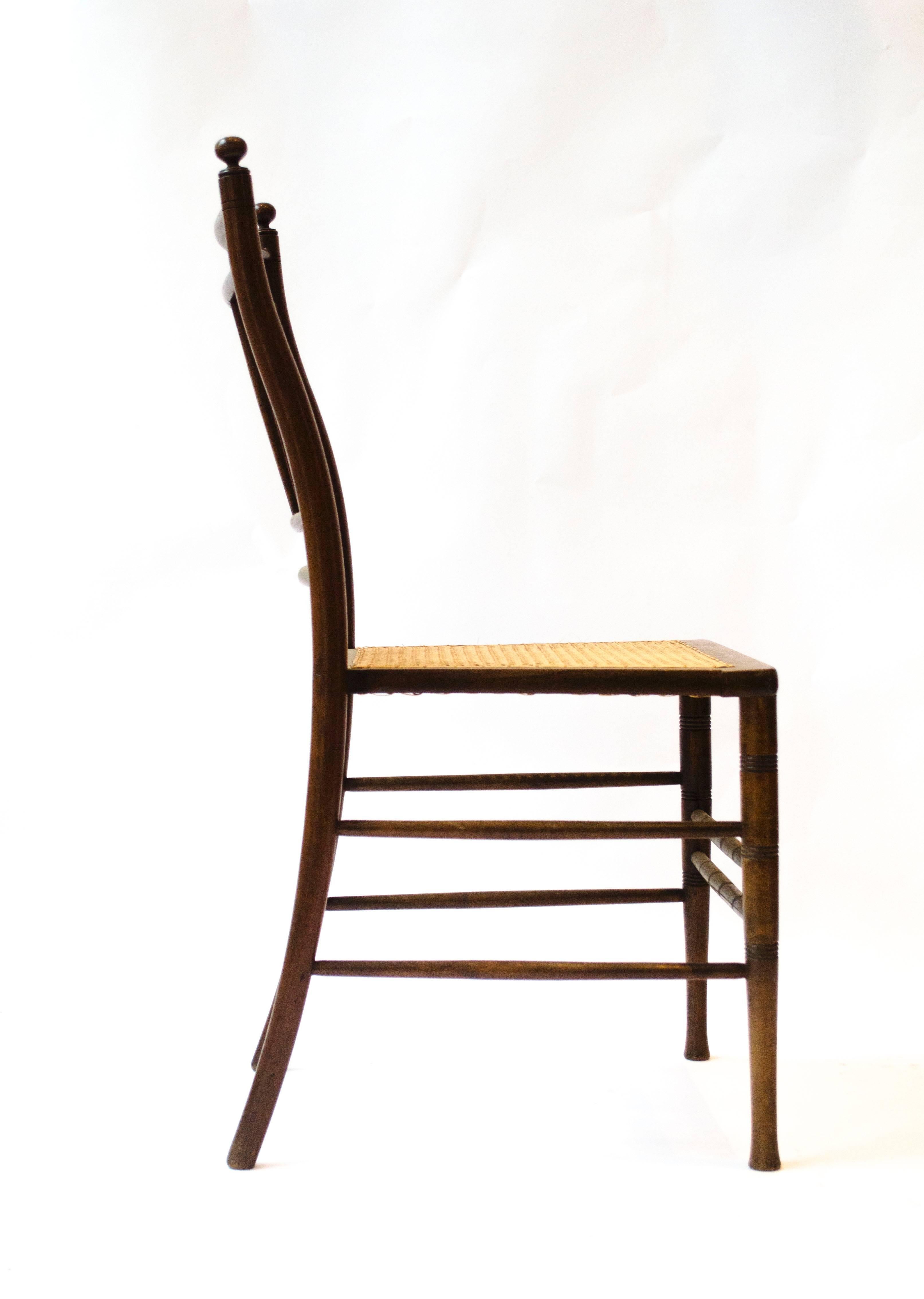 Anglo-Japanese walnut side chair, attributed to E W Godwin.
Probably made by William Watt.
The turnings to the back rest and the turned legs and stretchers with incised or scribed detailed lines grouped in sets of three are all details from other