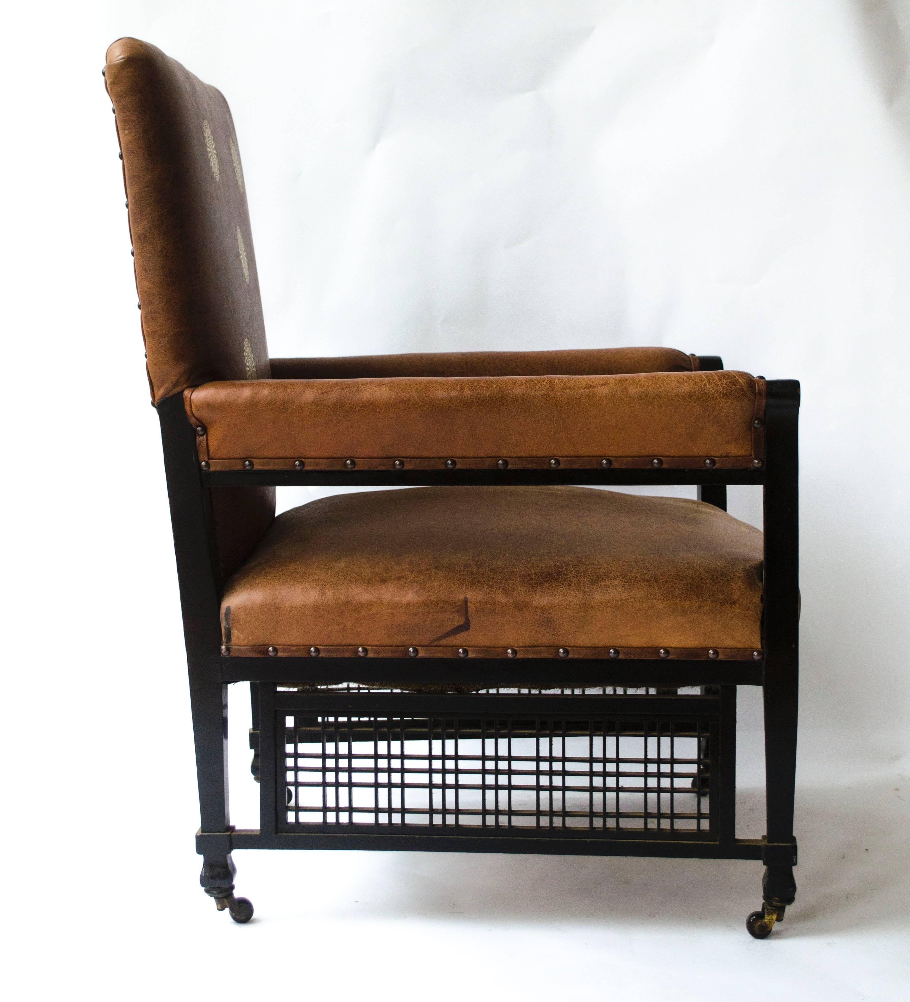 EW Godwin Design. Attr. An Anglo-Japanese armchair with slightly curved pagoda shaped arms and fine lattice detailing to the lower sides with uniting stretchers to the square legs on original brass and ceramic castors. 
We have had this armchair