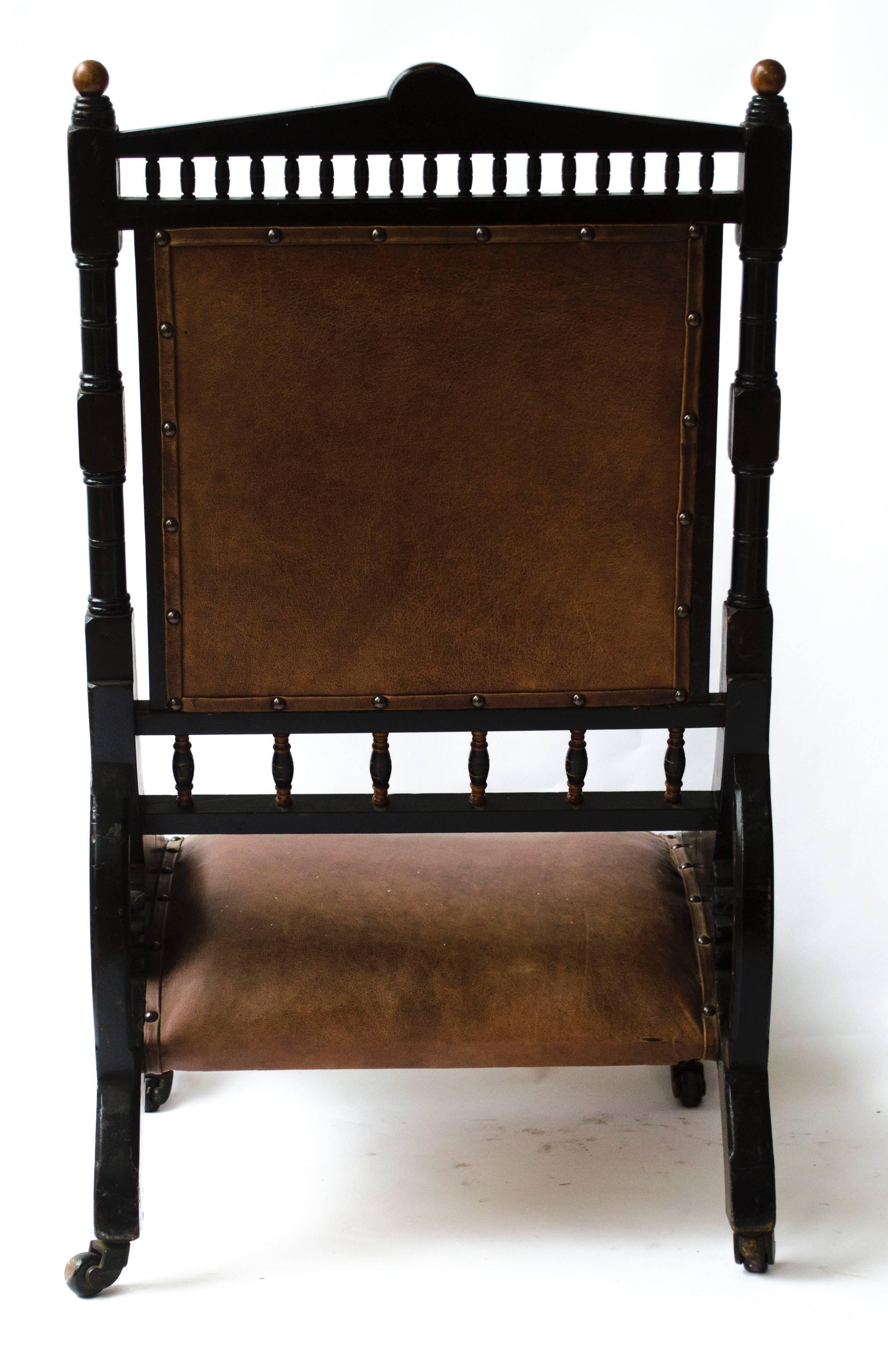English Richard Charles An Aesthetic Movement Ebonized and Parcel Gilt Lounge Chair.