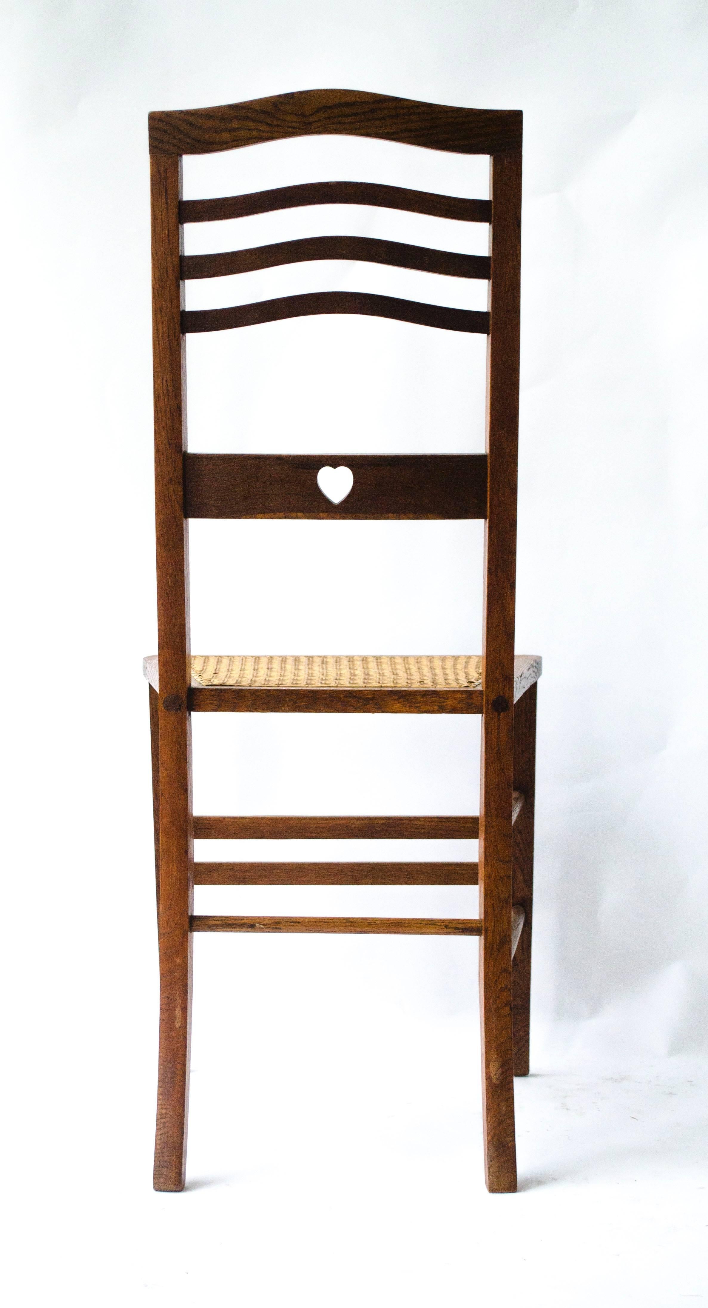 Arts and Crafts Shapland & Petter An Arts & Crafts Inlaid Oak Side Chair with a Pierced Heart For Sale
