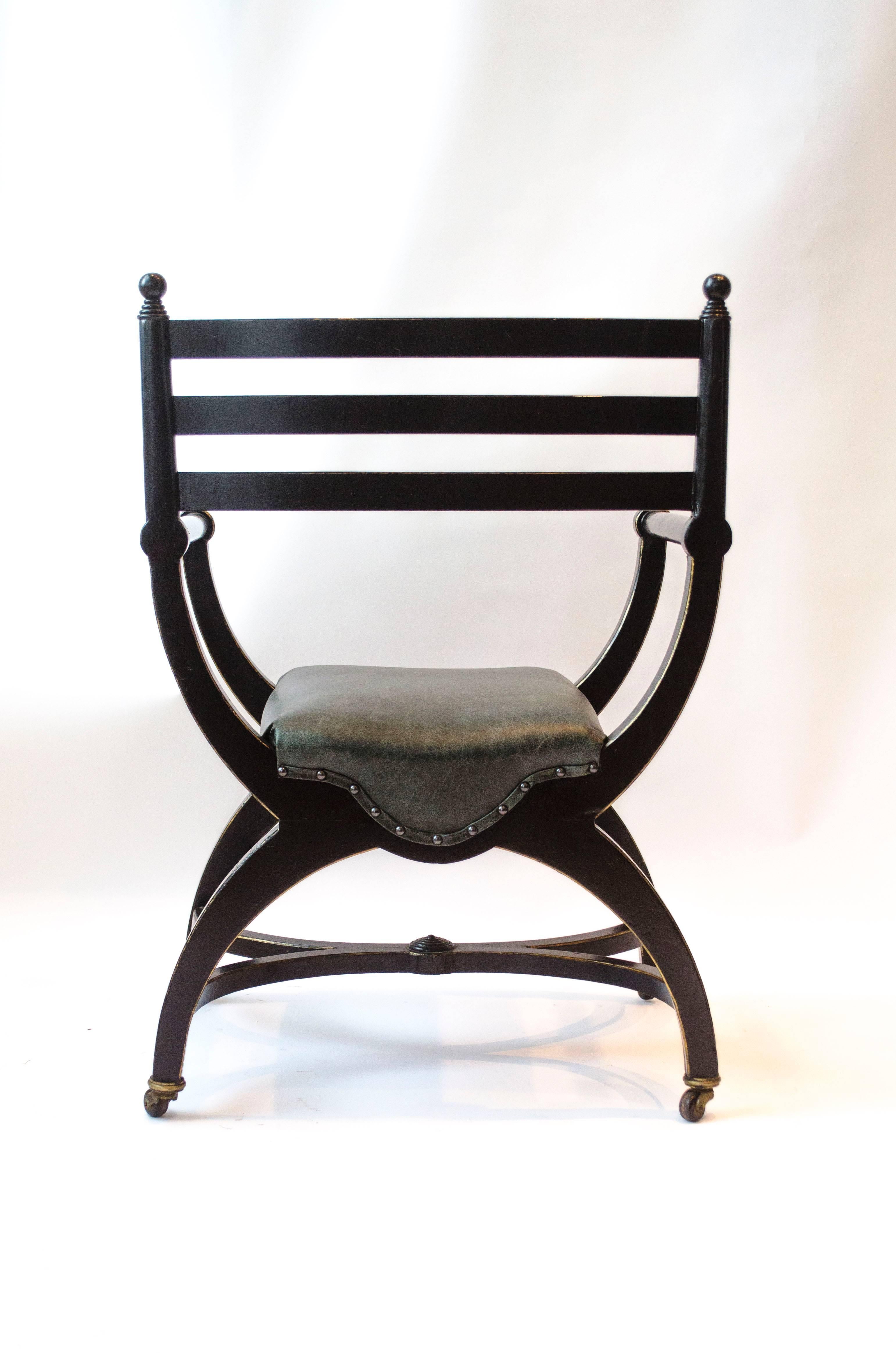 English Richard Charles Aesthetic Movement Ebonised Elbow Chair with X Frame stretcher For Sale