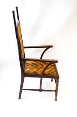 Liberty and Co Attributed. A late Aesthetic Movement Walnut Armchair.