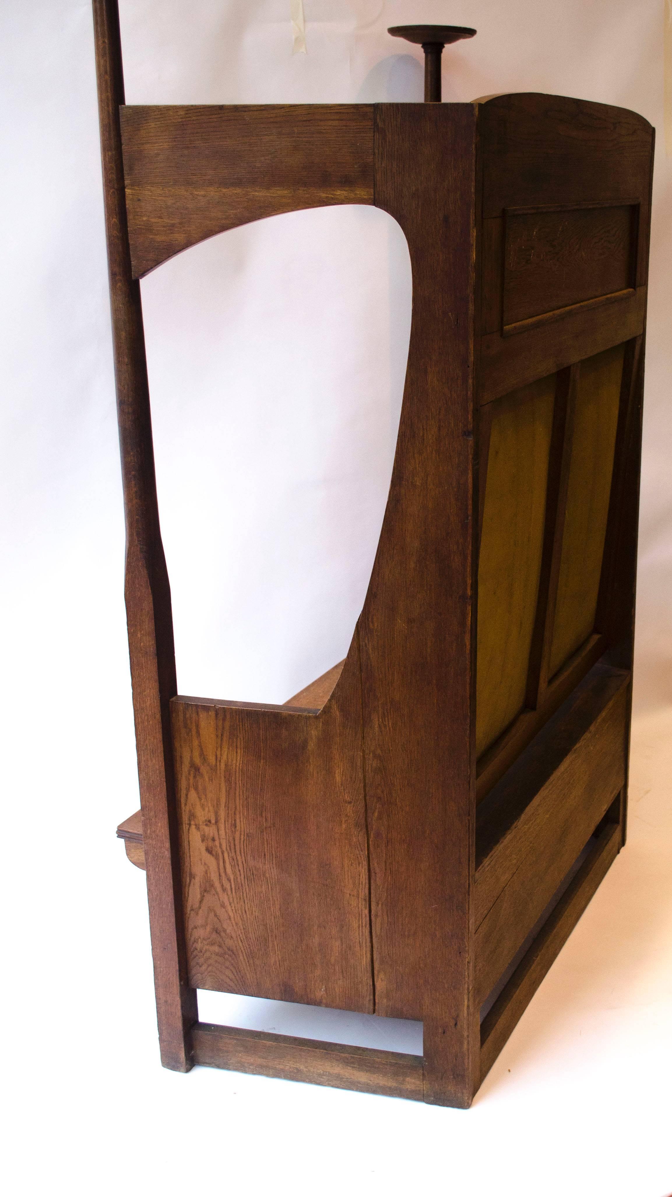 Arts and Crafts Liberty & Co. An Arts & Crafts Oak Settle in the Style of CFA Voysey