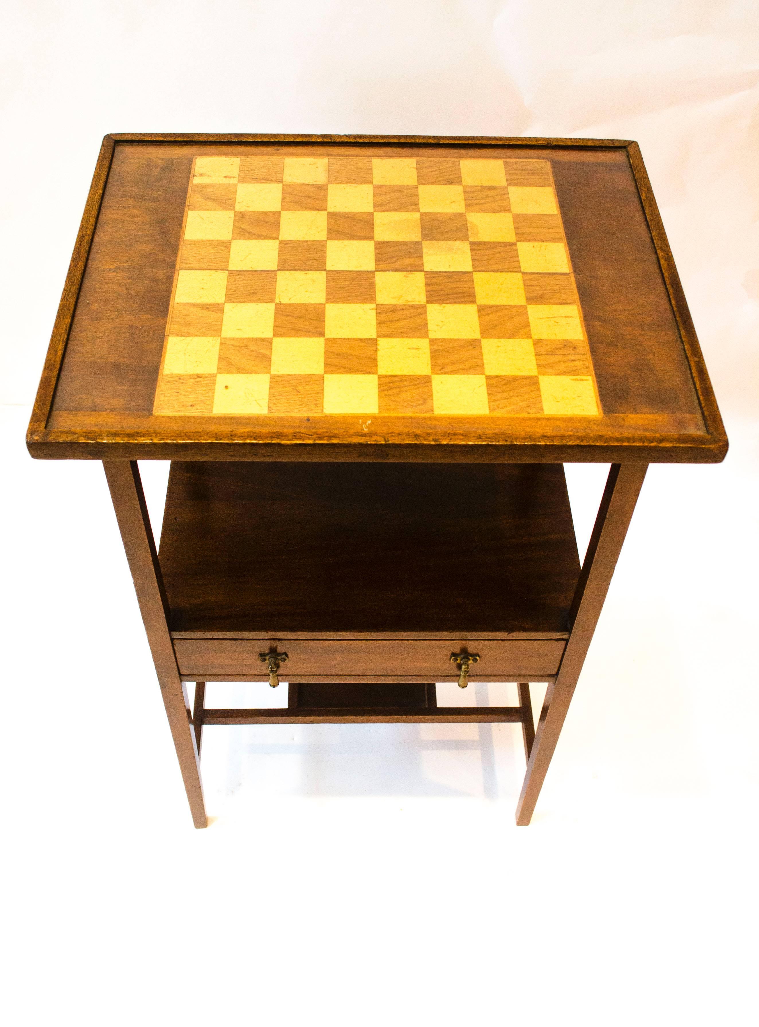 Edward William Godwin (attributed), probably made by William Watt, an early mahogany and inlaid single drawer chess table with original brass handles with dot decoration to the handle drops on square legs united by twin stretchers united by a small