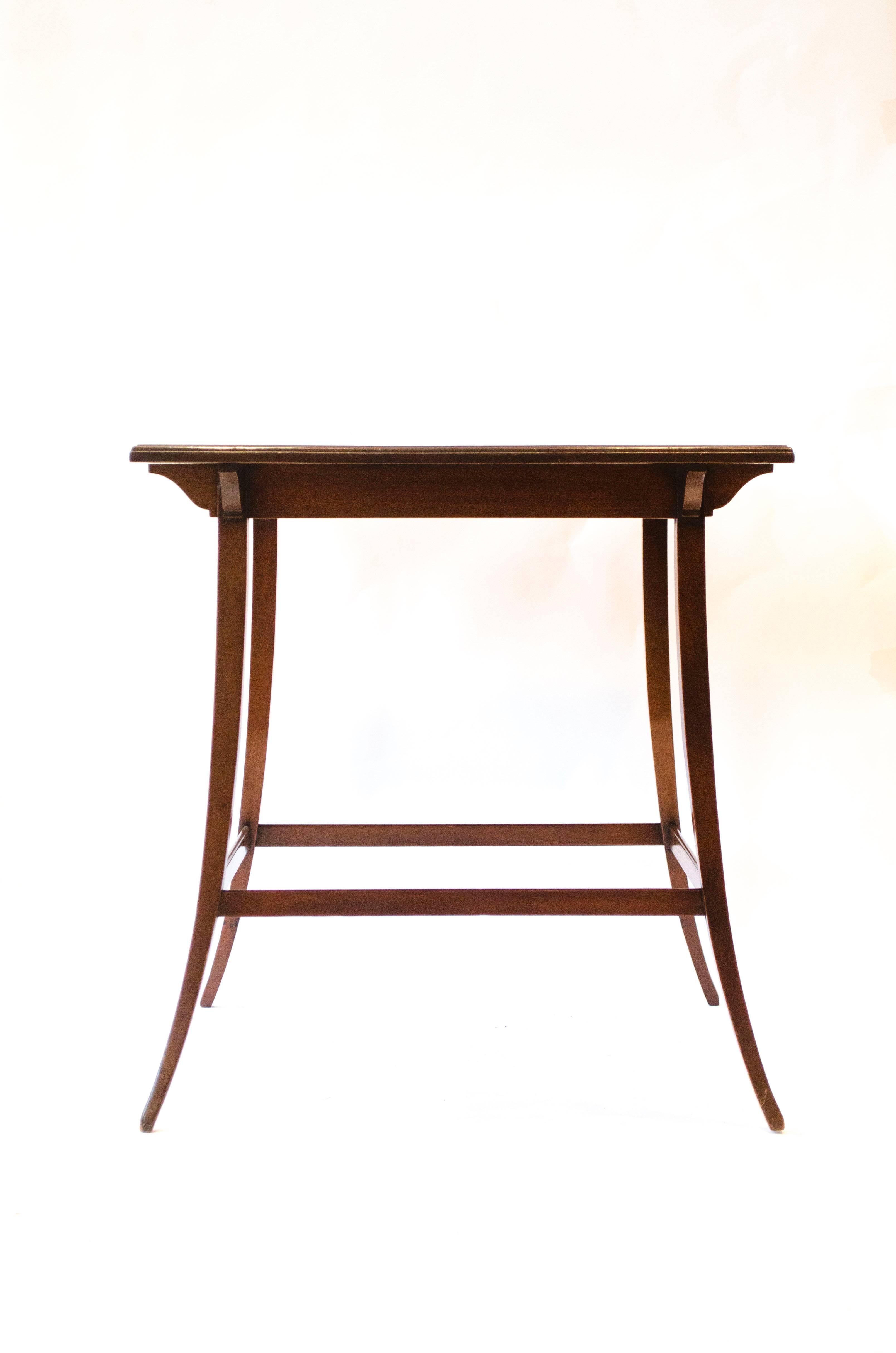 A mahogany tea table attributed to Edward William Godwin.