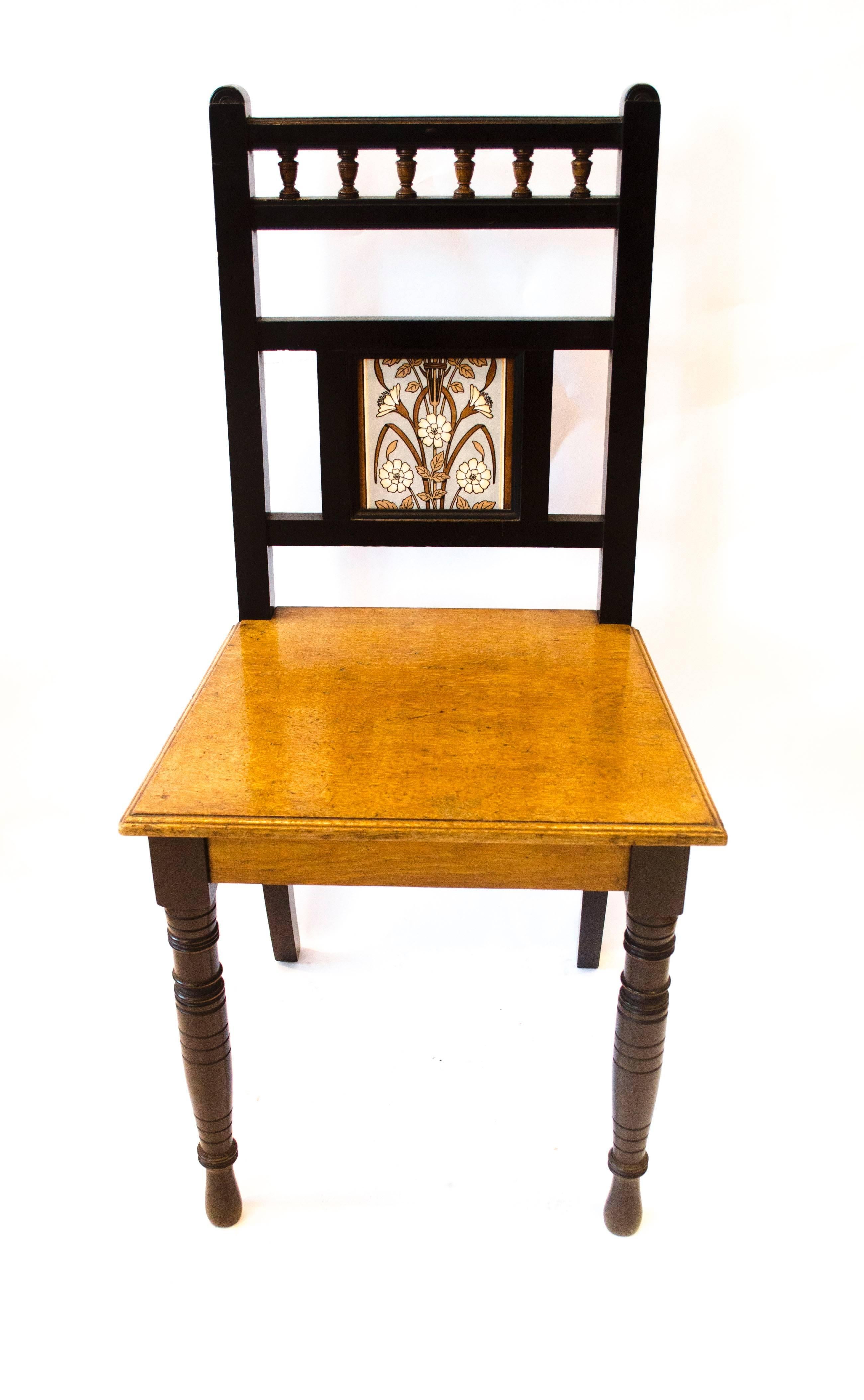 Bruce Talbert (attributed), an ebonized and walnut hall chair, inset with Minton's tile designed by Dr Christopher Dresser.

