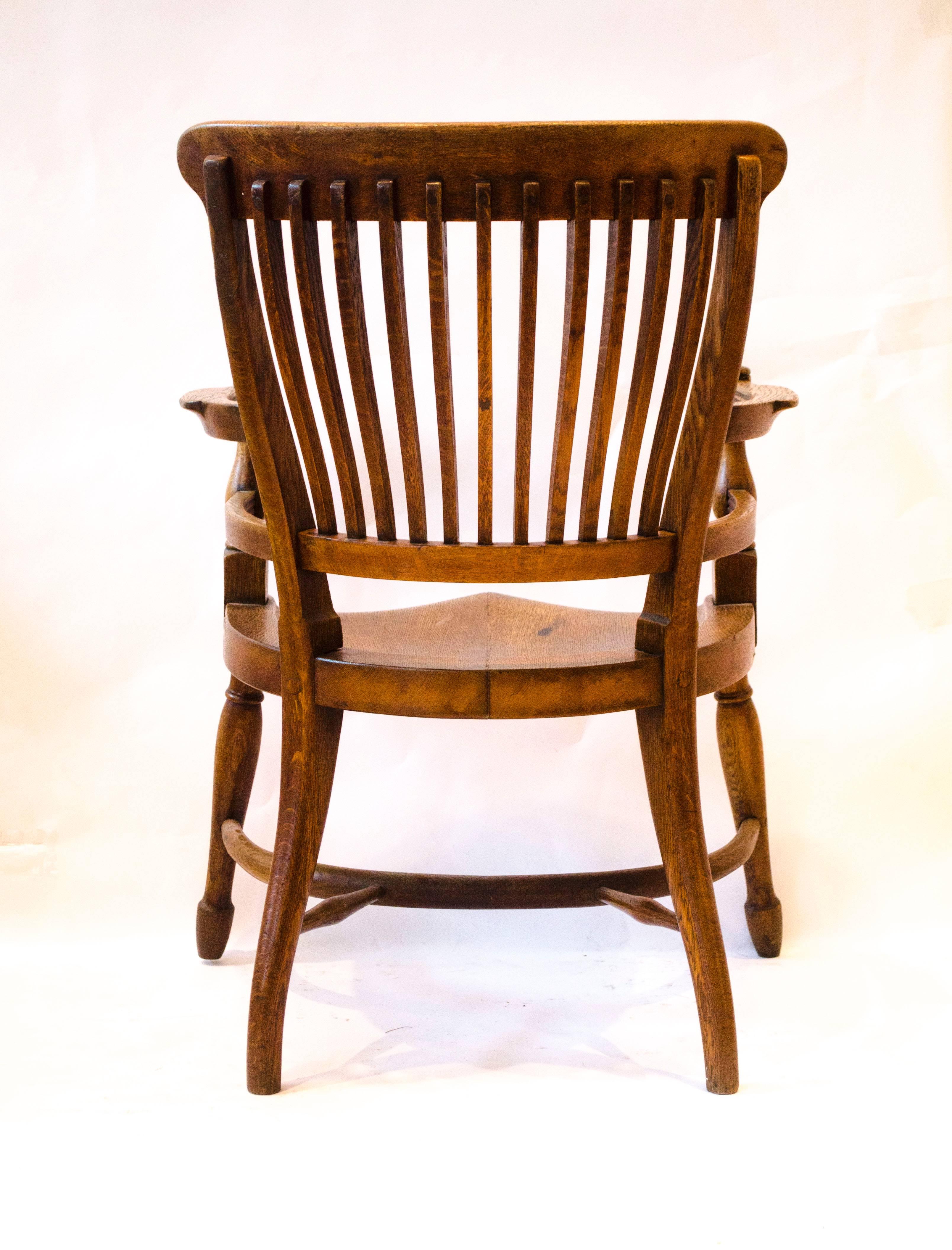 E W Godwin. Attr, An oak armchair with shaped back & a crinoline hoop stretcher In Good Condition For Sale In London, GB