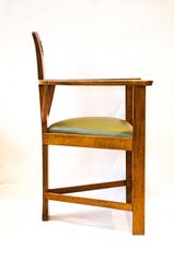 M H Baillie Scott. An Arts & Crafts Walnut Armchair with stylised floral carving