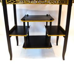 Heals. An Anglo-Japanese Ebonised Side Table with Gilt Fretwork and Flaring Ends