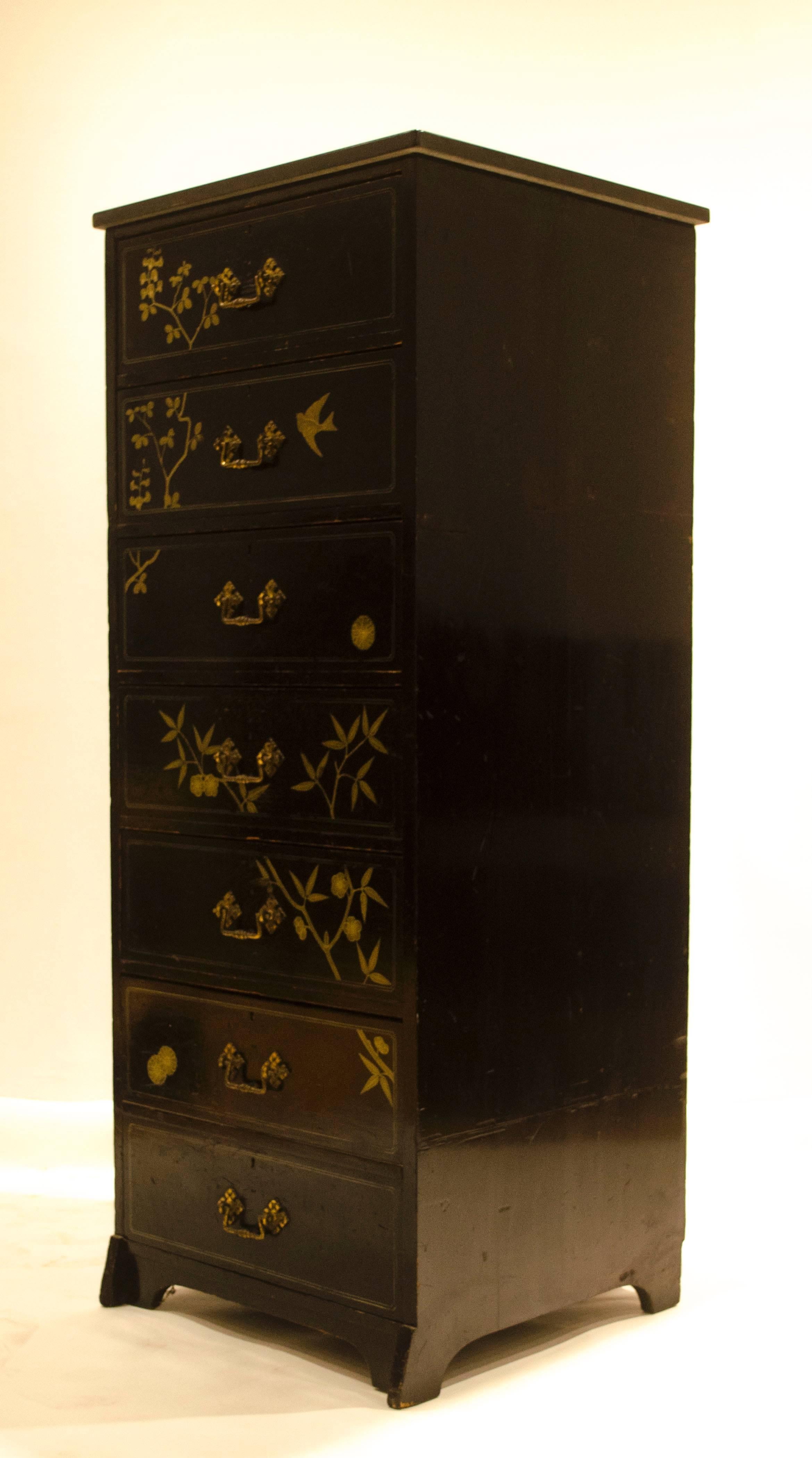 A rare and early Anglo-Japanese ebonized tall chest of drawers, designed by Daniel Cottier with gilt painted swallow, stylized bamboo and plant forms with rosettes with a later black marble-top, the lower drawer a double. 

The last three images