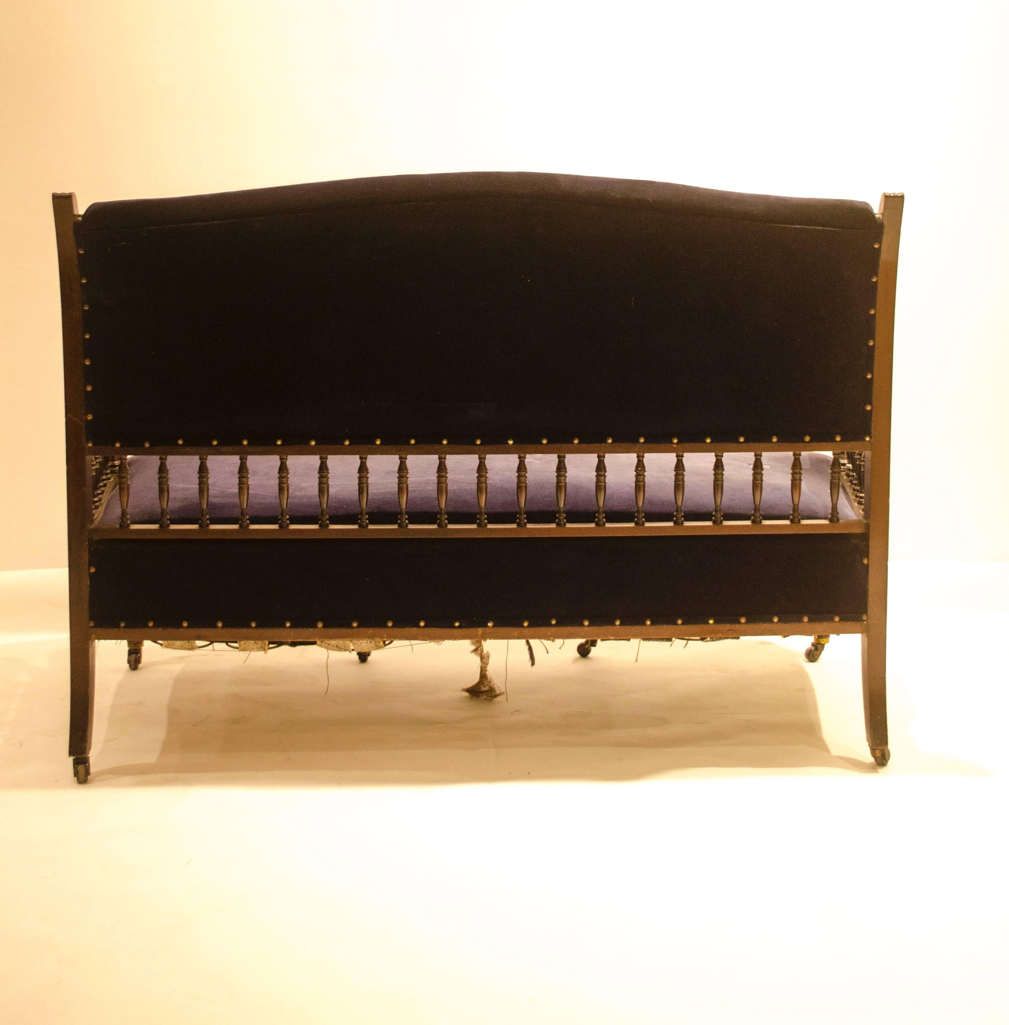 English Collinson & Lock. An Anglo-Japanese Mahogany Settee with carved & scrolled arms For Sale