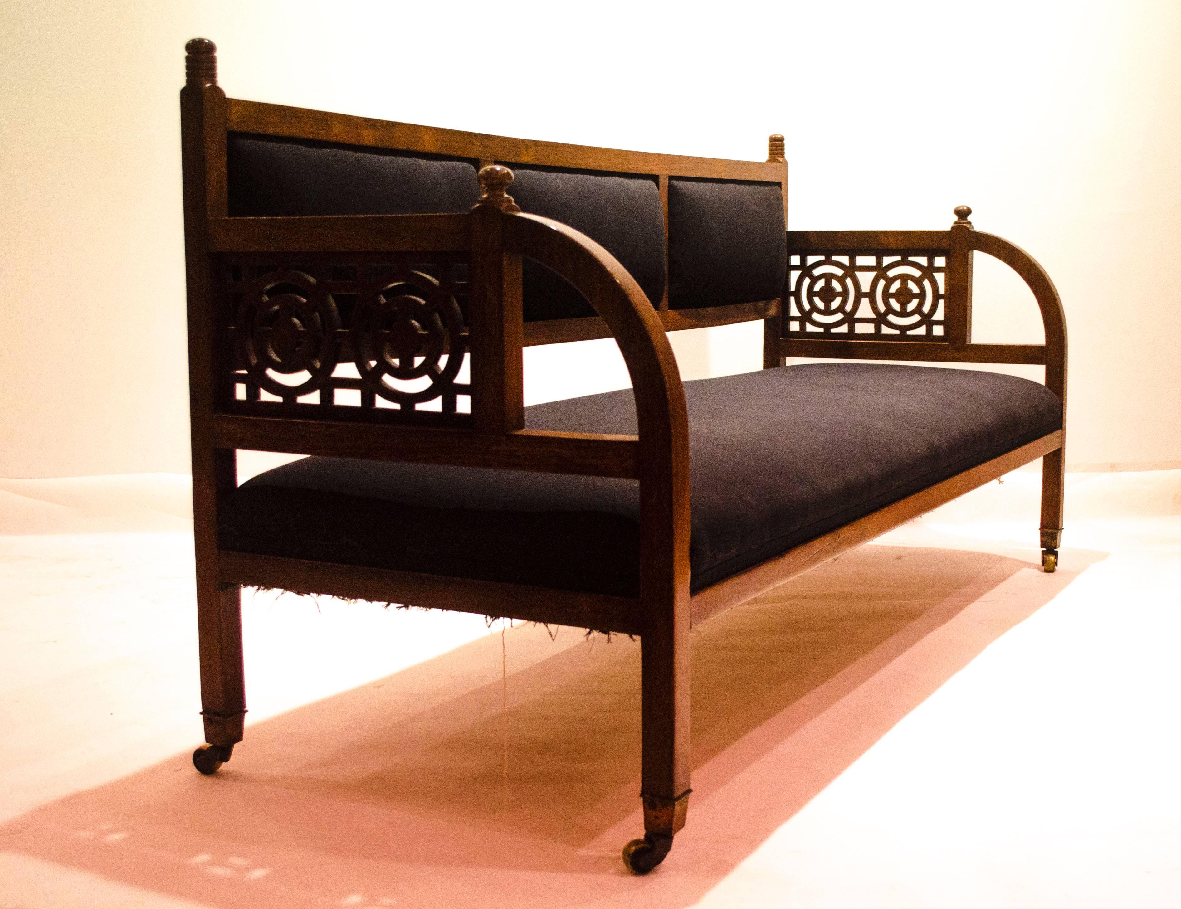Edward William Godwin. A rare Anglo-Japanese walnut settee originally designed for Dromore Castle, County Limerick, for Lord Limerick.
A similar example of the present lot is in the collections of the Victoria and Albert Museum, London and Bristol