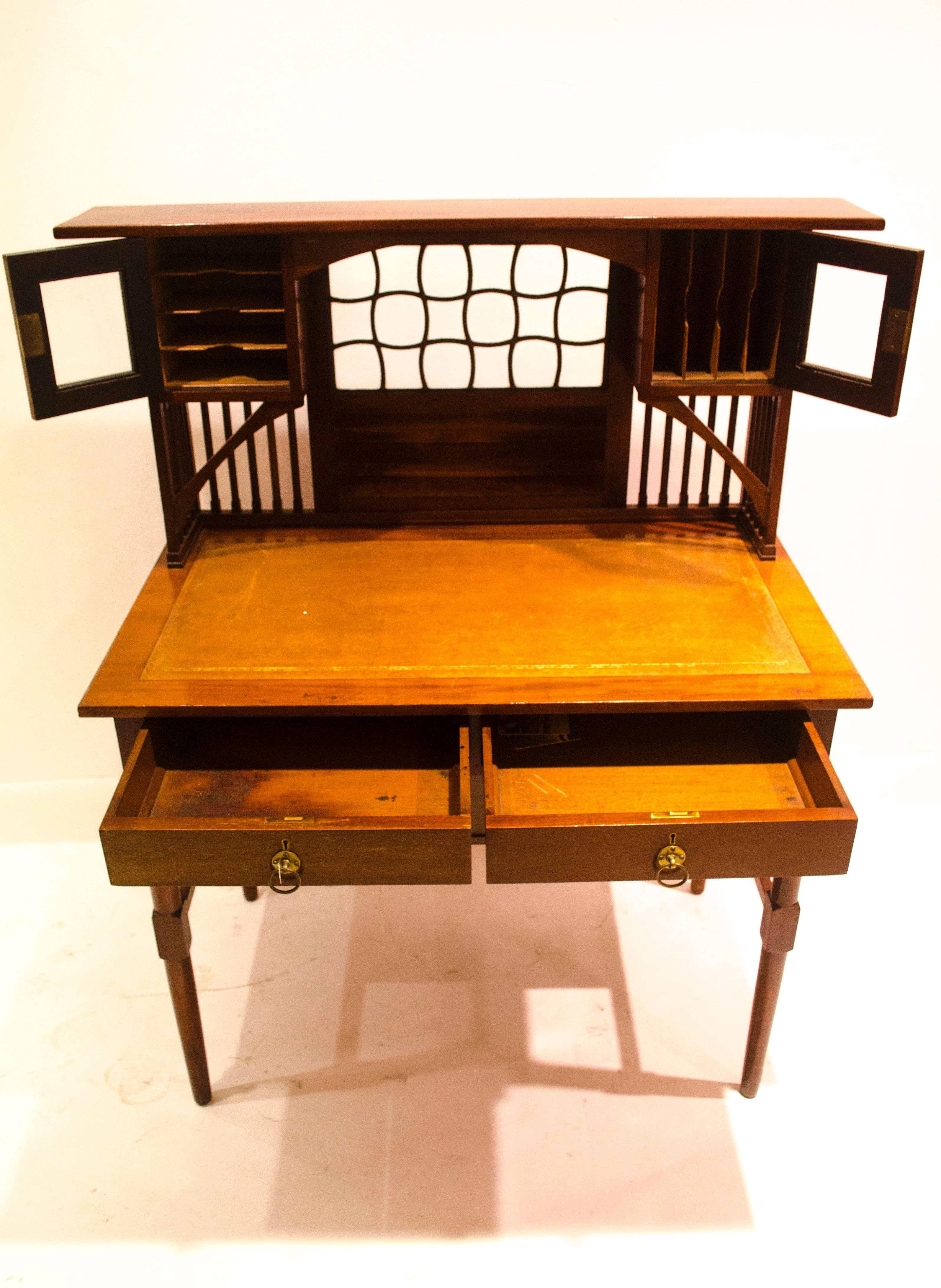 E. W. Godwin, Attr An Anglo-Japanese four drawer writing table. 
The front legs are identical to the Dromore Castle dining chairs with slightly rounded feet.  A compact design, the upper cupboards with horizontal and vertical paper compartments.