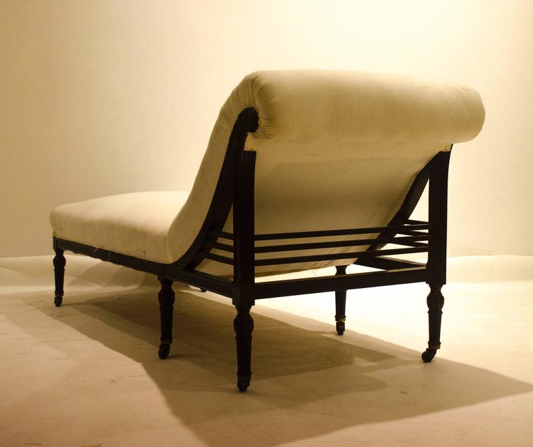 E W Godwin. Made by Collinson And Lock. A Rare Anglo-Japanese Rosewood chaise lounge or day bed with finely carved floral work to the upper end and spiral turned legs on original brass castors.
See Susan Weber Soros. Page 106.
Professionally re