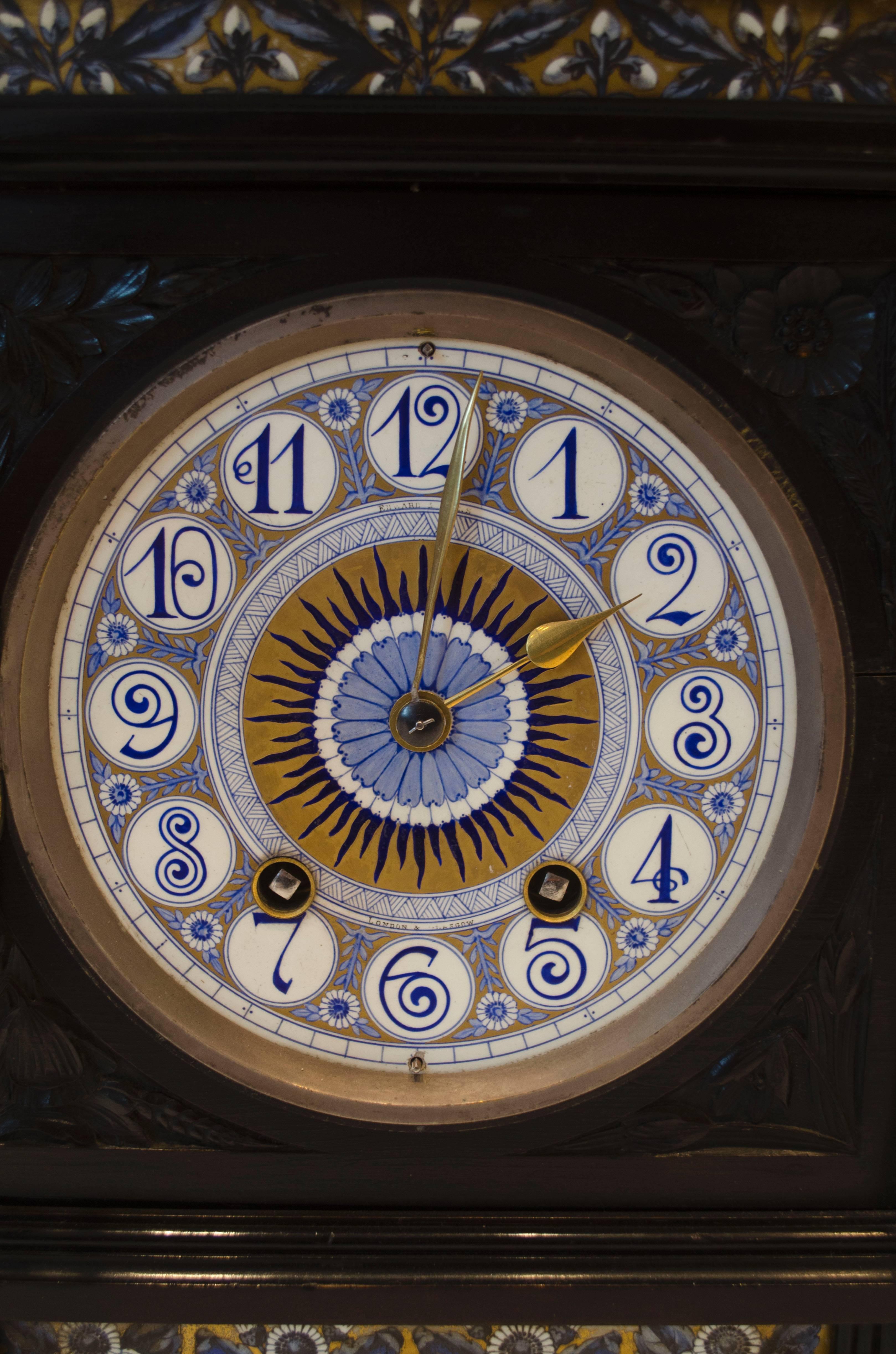 Lewis Foreman Day, an Aesthetic Movement ebonized mantel clock, the gong-striking eight-day movement with an Arabic numeral 6 inch dial with blue and gilt flower and sunburst painted panels.
See 'Victorian and Edwardian Decorative Art: The