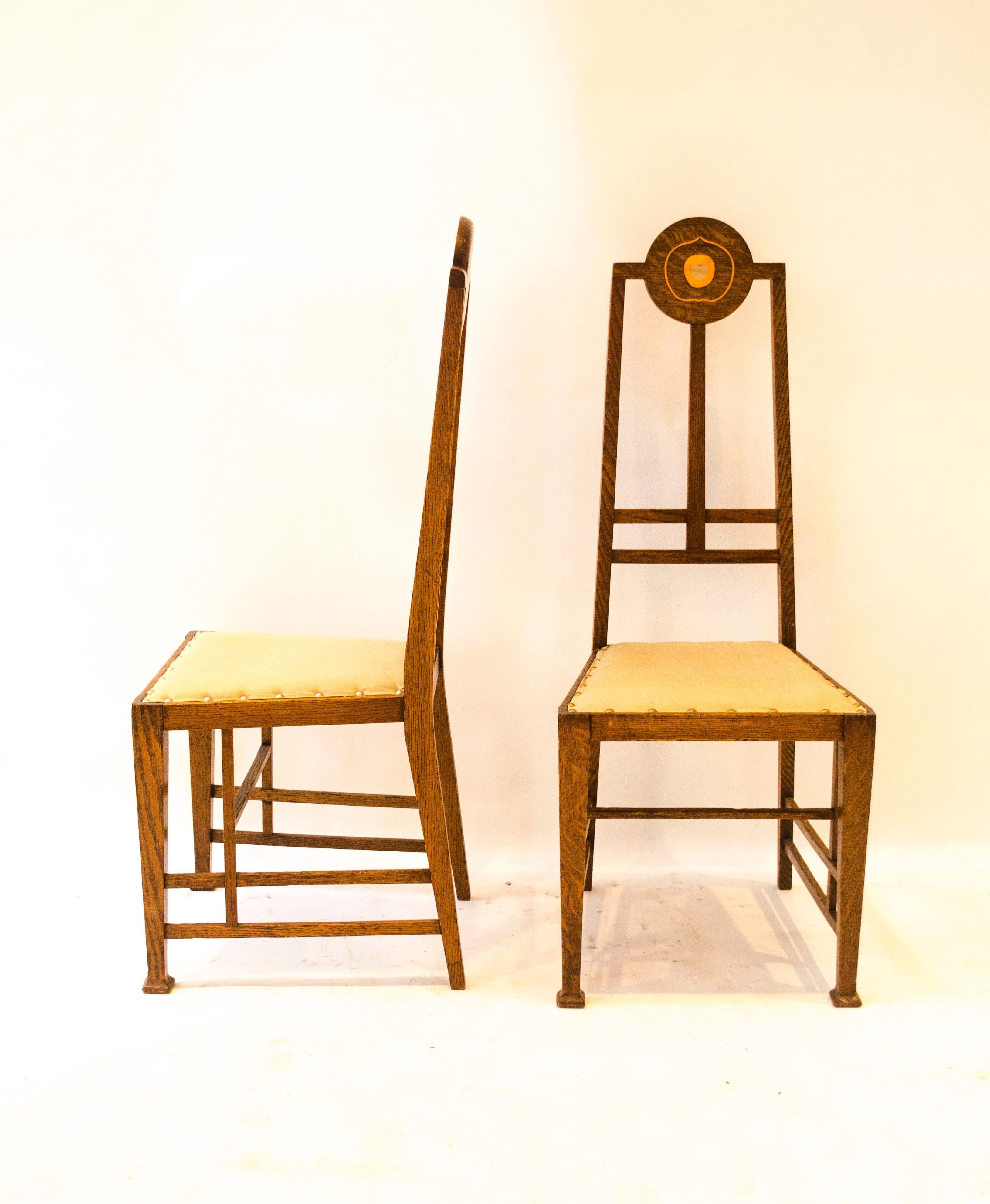 Designed by George Montague Ellwood (1875-1955) and made by J S Henry (John Sollie Henry, founded circa 1880) of Old Street, London.
A pair of exceptional Arts & Crafts oak side chairs designed by George Montague Ellwood and made by J S Henry,