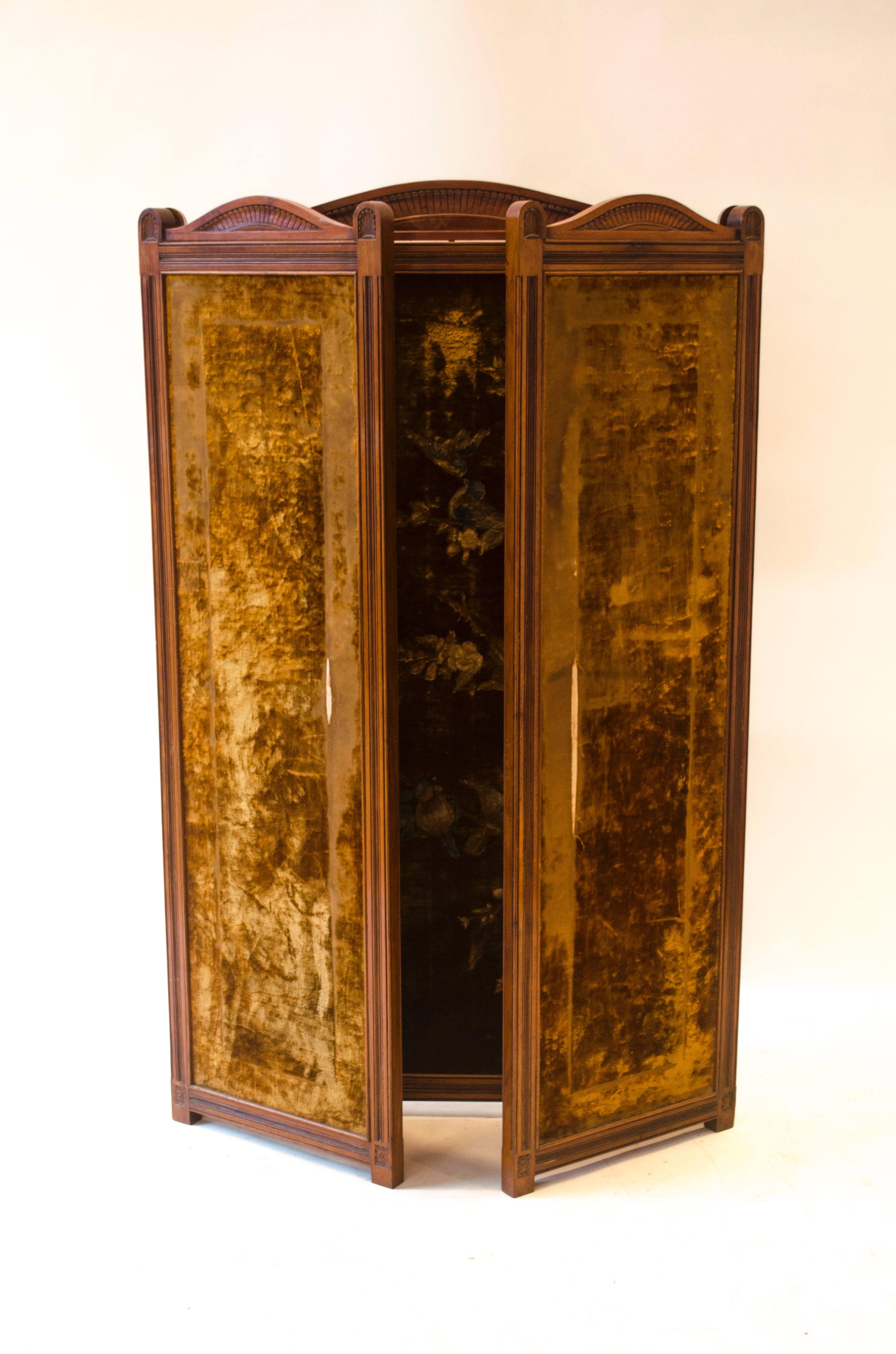 Bruce Talbert in the style of and probably made by Gillows. 
An Aesthetic Movement Walnut three-fold screen with carved serpentine and palm leaf decoration to the tops and tramline detail to the frames and six carved florets to the bottom of each