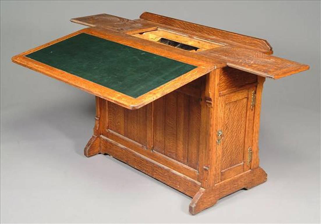 Attributed to Gillows of Lancaster. A rare Gothic Revival architect's folding desk. The top has opposing slides opening to reveal a compartment for storing drawing utensils etc. The folding leather work area has three different working positions and