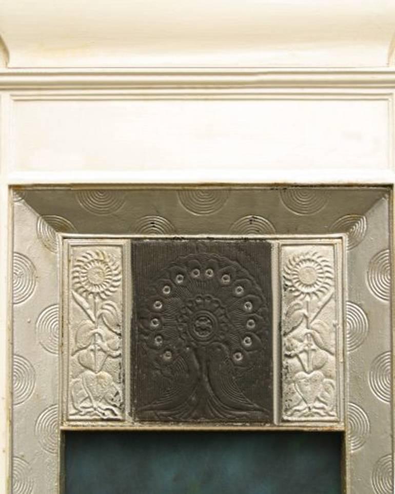 An Aesthetic Movement cast iron fireplace with peacock feathers to the centre and two love birds just below flanked by Sunflowers. Made by Thomas Elsley the design attributed to Thomas Jeckyll.
We can have this stripped and polished or painted in