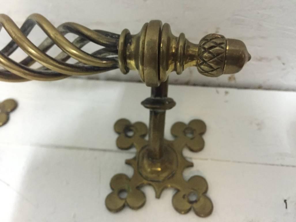 A W N Pugin attri, a single brass door handle is from the palace of Westminster and measures 9” long and protrudes 4 inches, each fixing sq 3 inches x 3 inches.