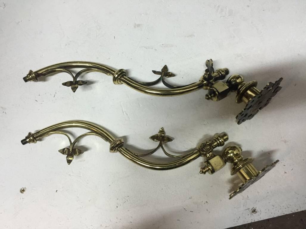 AWN Pugin A rare pair of Gothic Revival brass wall lights.
Provenance : Designed for Chirk Castle.
Last image from Pugin's, 'Ornament of the 15th & 16th Century'.
They will easily convert to electricity without adapting or changing them. 
They