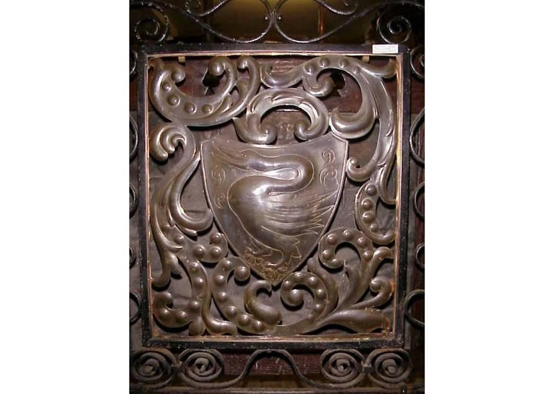 An Arts and Crafts fire screen attributed to John Pearson with hand-forged iron frame and a central copper panel also hand worked depicting a swan within a shield within floral details. 

Measures: Height 32" 82cm, width 21" 54cm, depth of