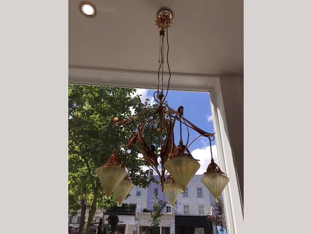 W. A. S. Benson. 1854 - 1924. and James Powell of Whitefriars. 
A rare and beautiful to nature chandelier with copper leaf plates and original James Powell Vaseline conical shades with copper petal collars, each etched with Rd Numbers. 
An