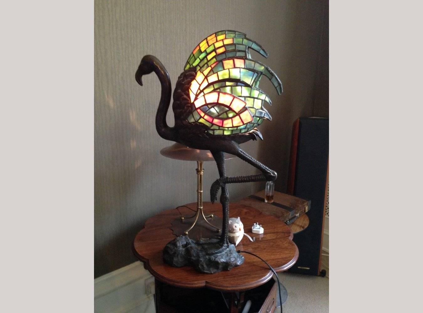Alberic Collin. A bronze table lamp modelled as a Flamingo with a Mosaic stain glass shade in the form of colourful feathers hand made in Tiffany style coloured glass.
Biography: Alberic Collin was born on April 6th 1886 at Antwerp, and was to