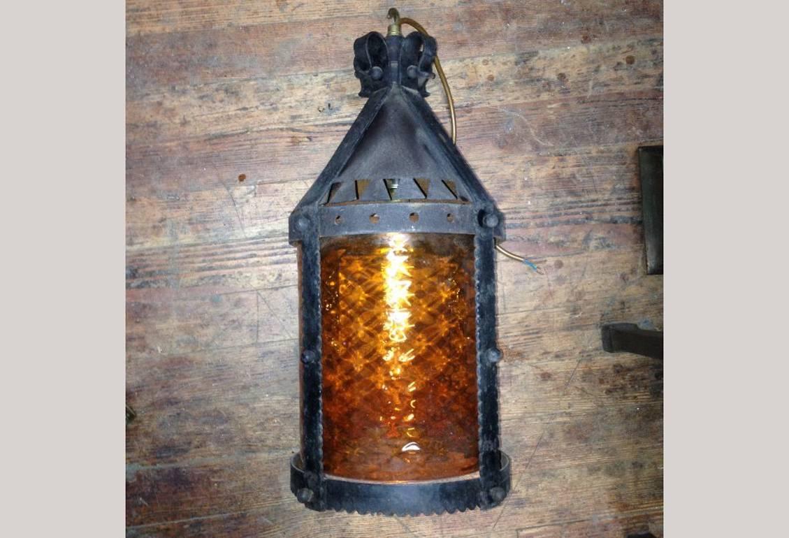 A large Arts and Crafts iron lantern retaining the original dappled amber shade.

 