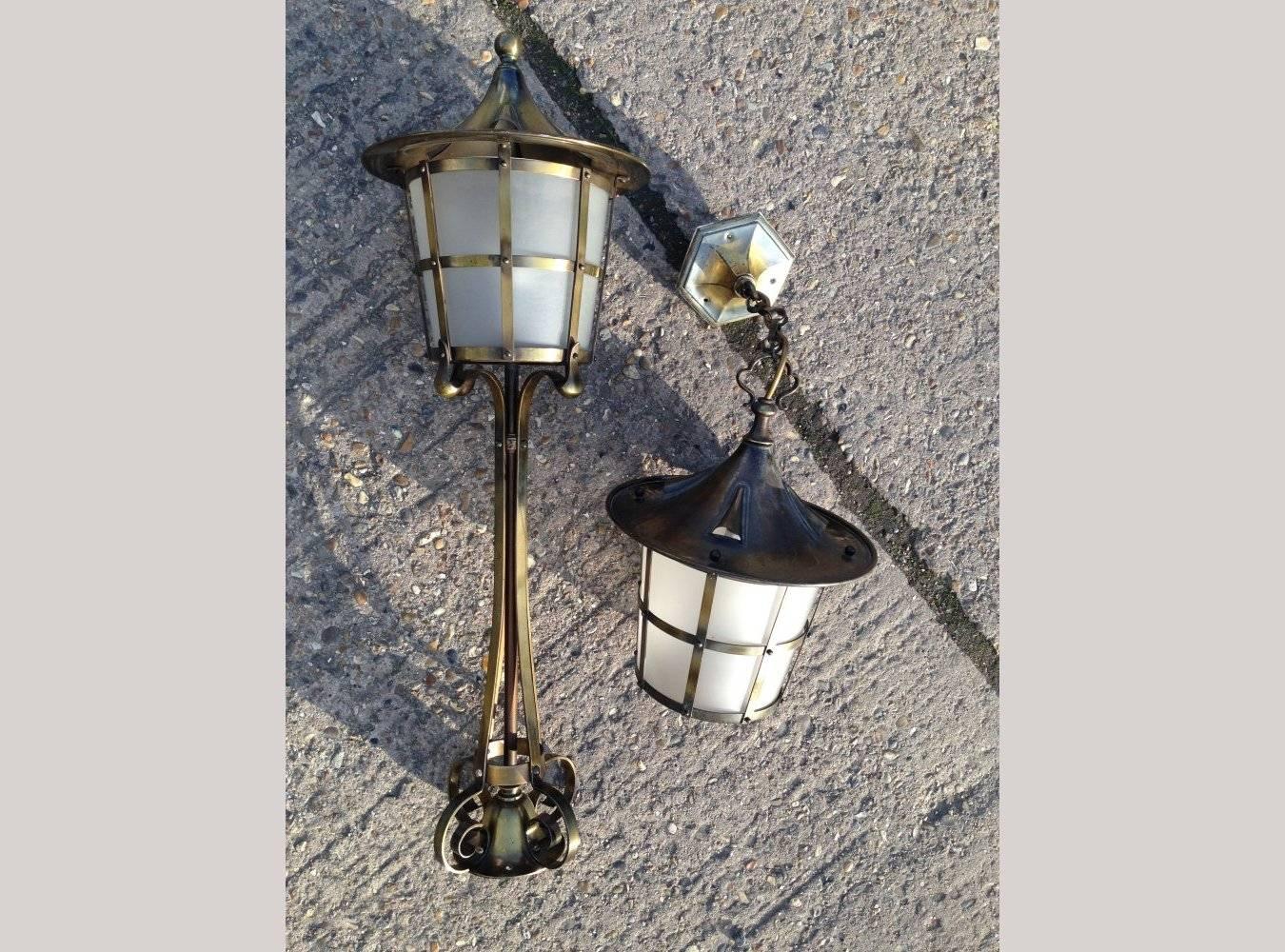 An Arts and Crafts copper stair post lantern with matching hall lantern.
Height 30 1/4, height hall lantern 13 1/2