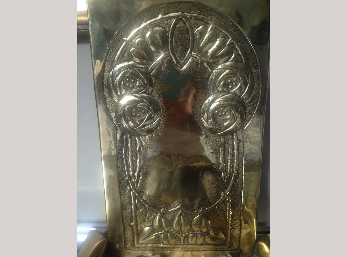 Margret Gilmour Attributed, A Glasgow School brass candle sconce with stylised Glasgow Roses and scroll details to the lower sides.

 