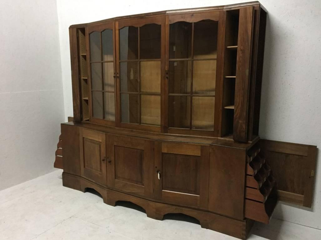 An important Cotswold School walnut breakfront glazed bookcase/cabinet designed by Edward Barnsley, and made by Charles Bray, dated 1932. 

Provenance Mrs D.E. Neale, commissioned in 1932. 
Exhibited from October to November 1982 by Fischer Fine Art