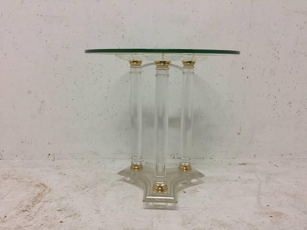 A French Mid-Century Modern circular Lucite and brass side table..